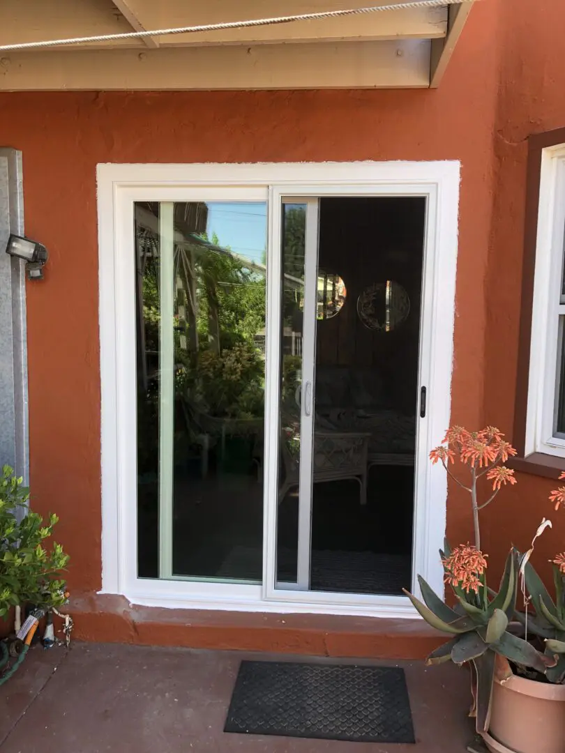 A sliding glass door in the middle of a patio.