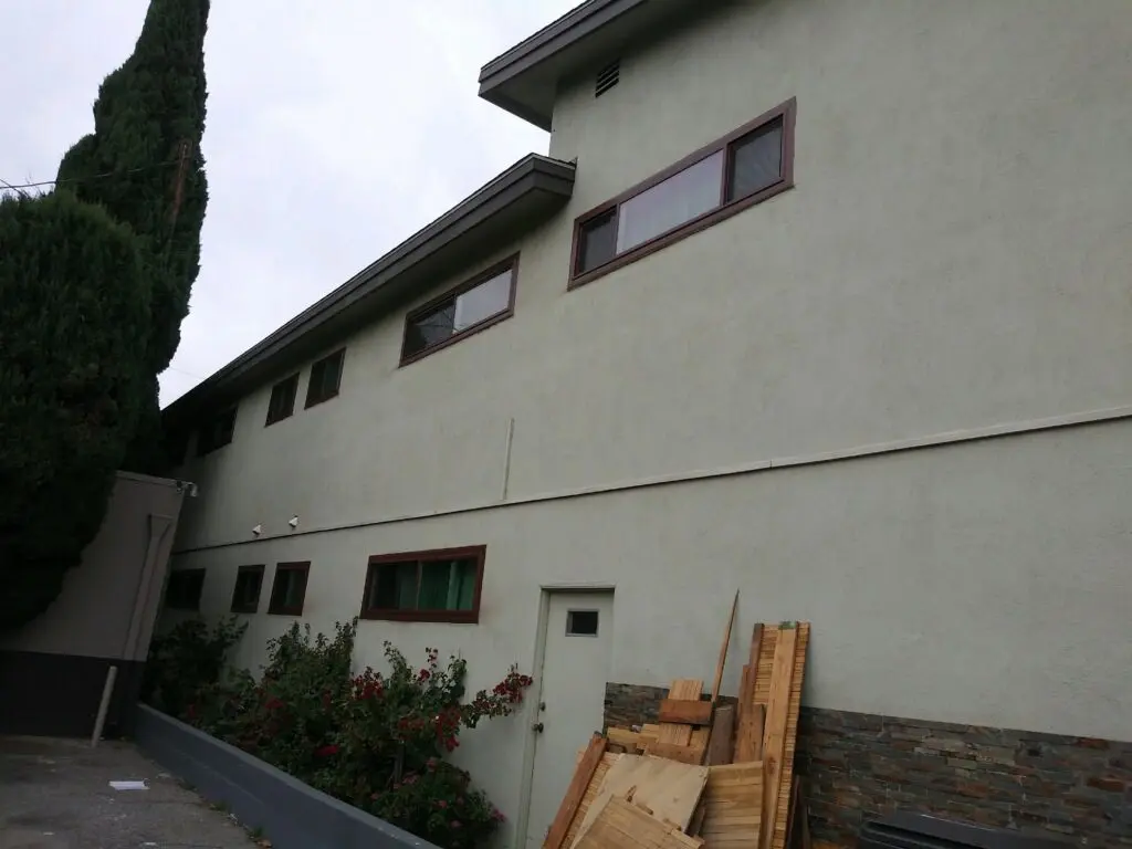A building with some wood on the side of it