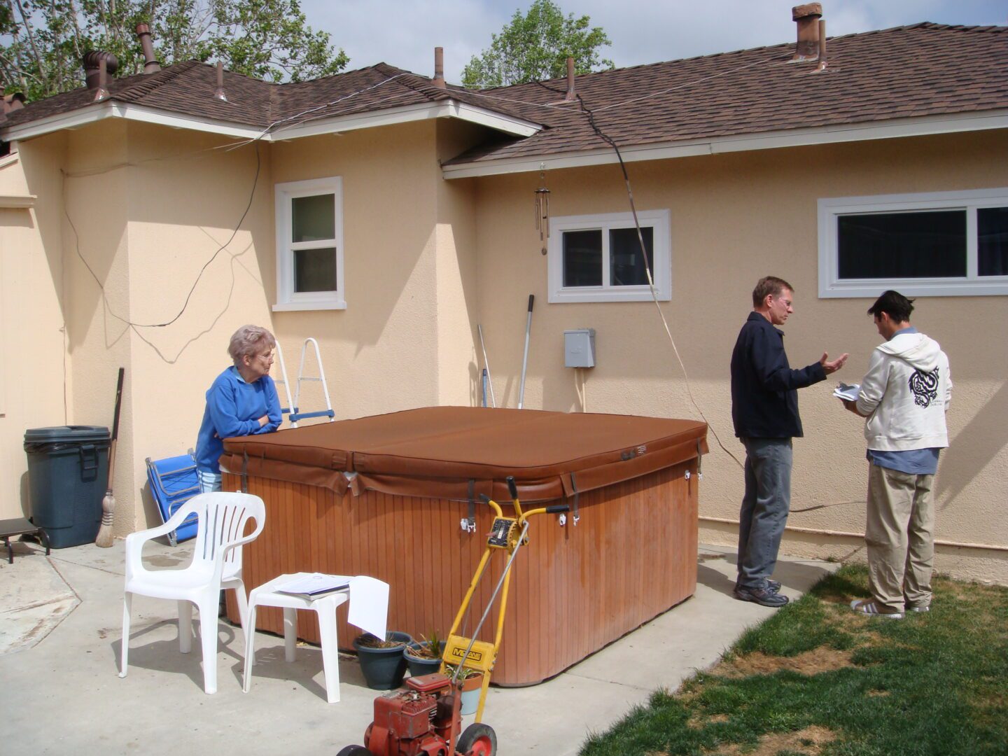 A group of people standing around a hot tub.