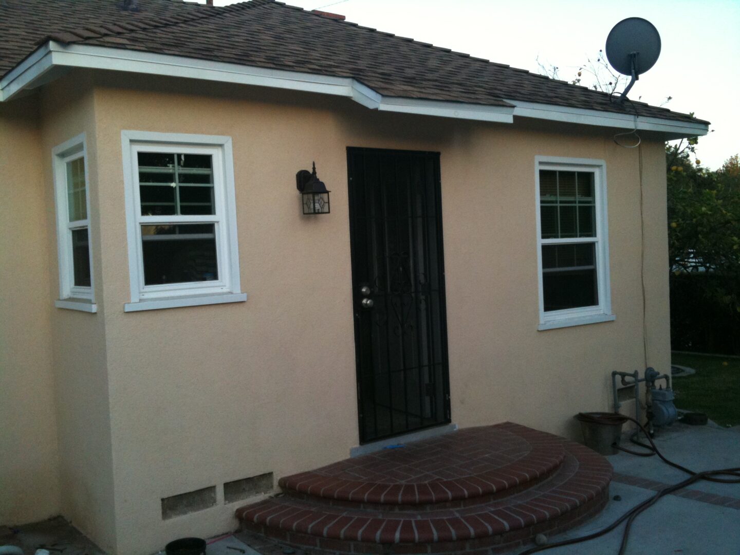 A house with a door open and a window closed.