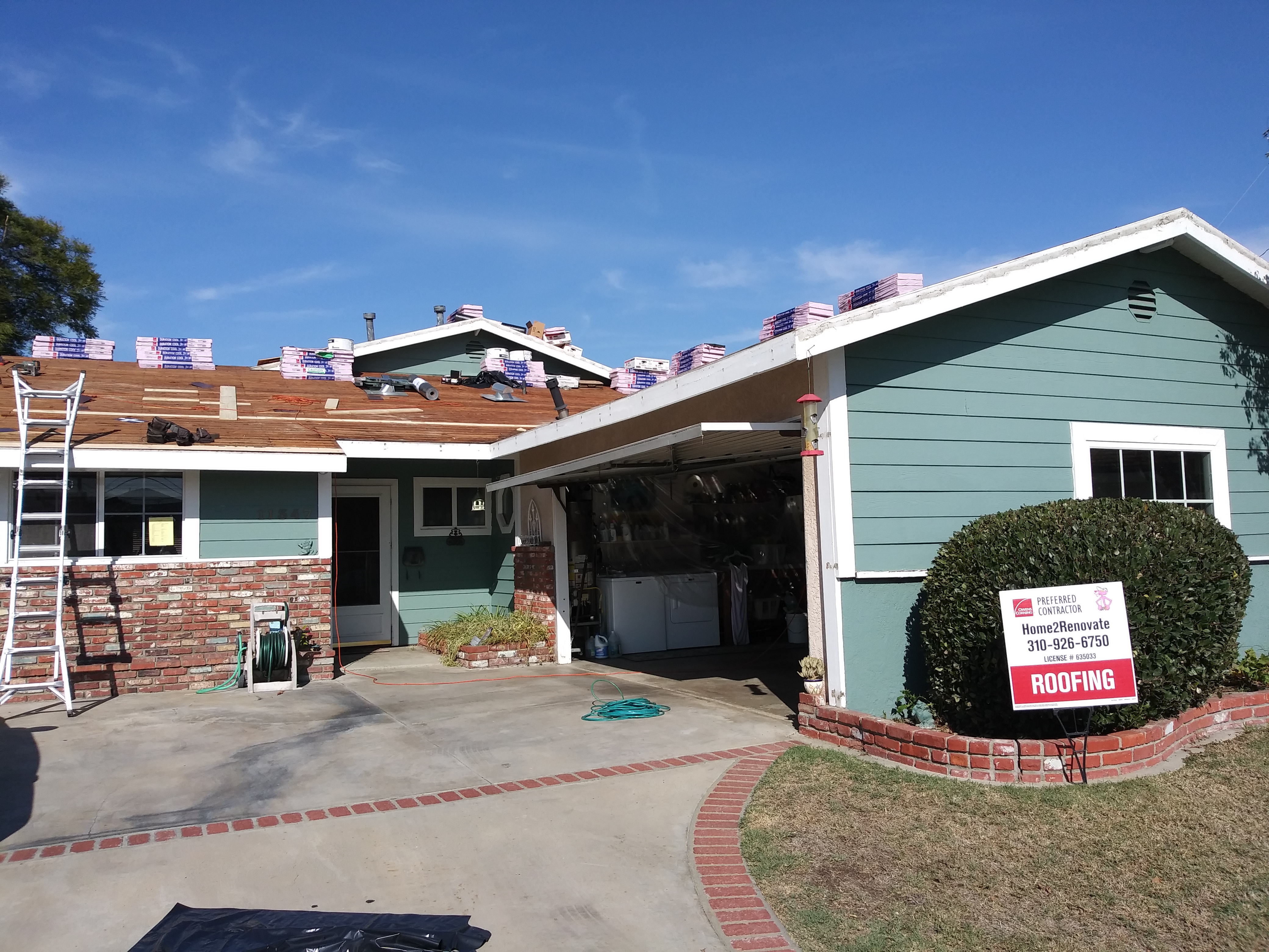 A house with a garage and a red brick driveway.