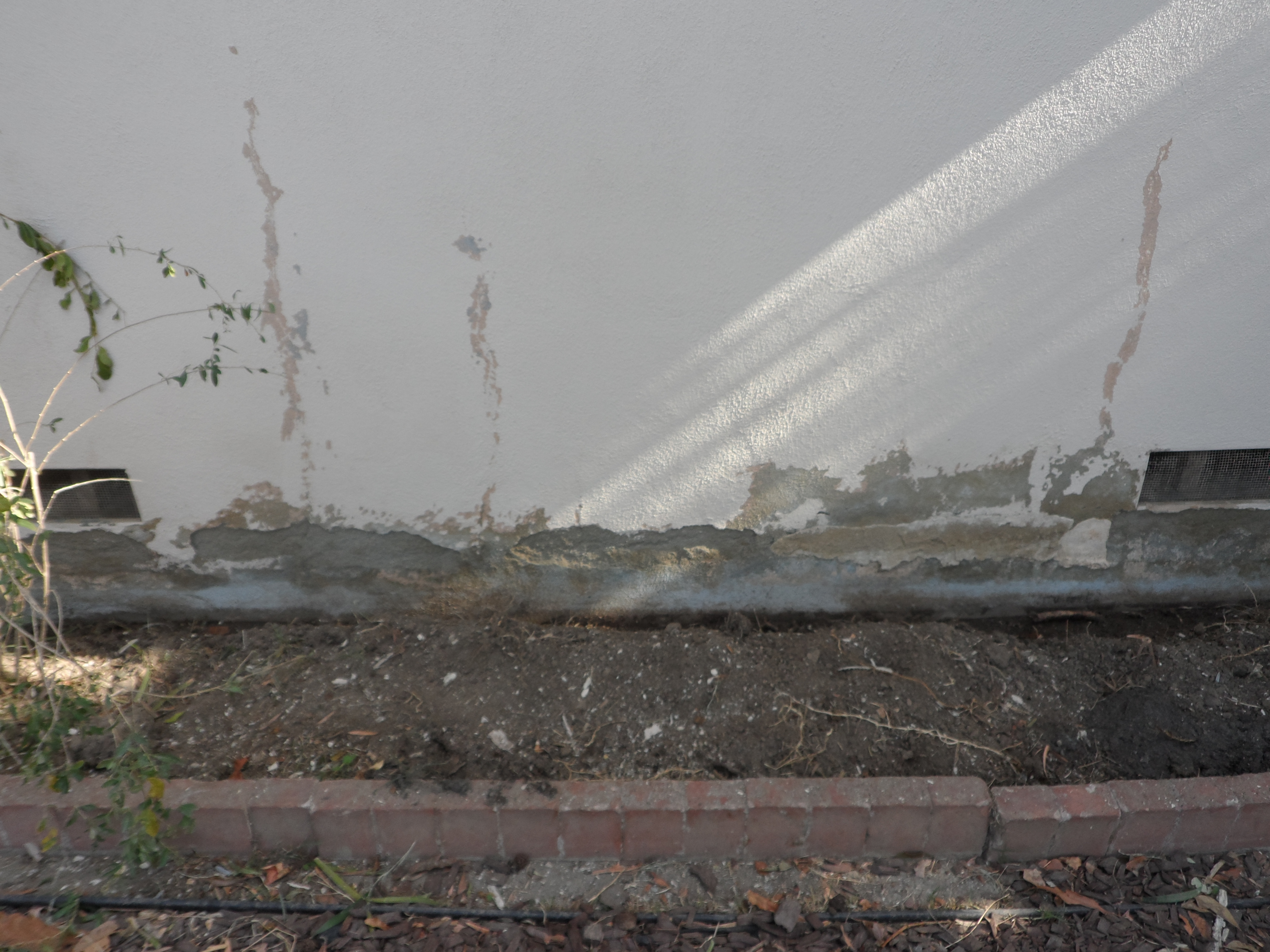 A close up of the side of a building with debris on it