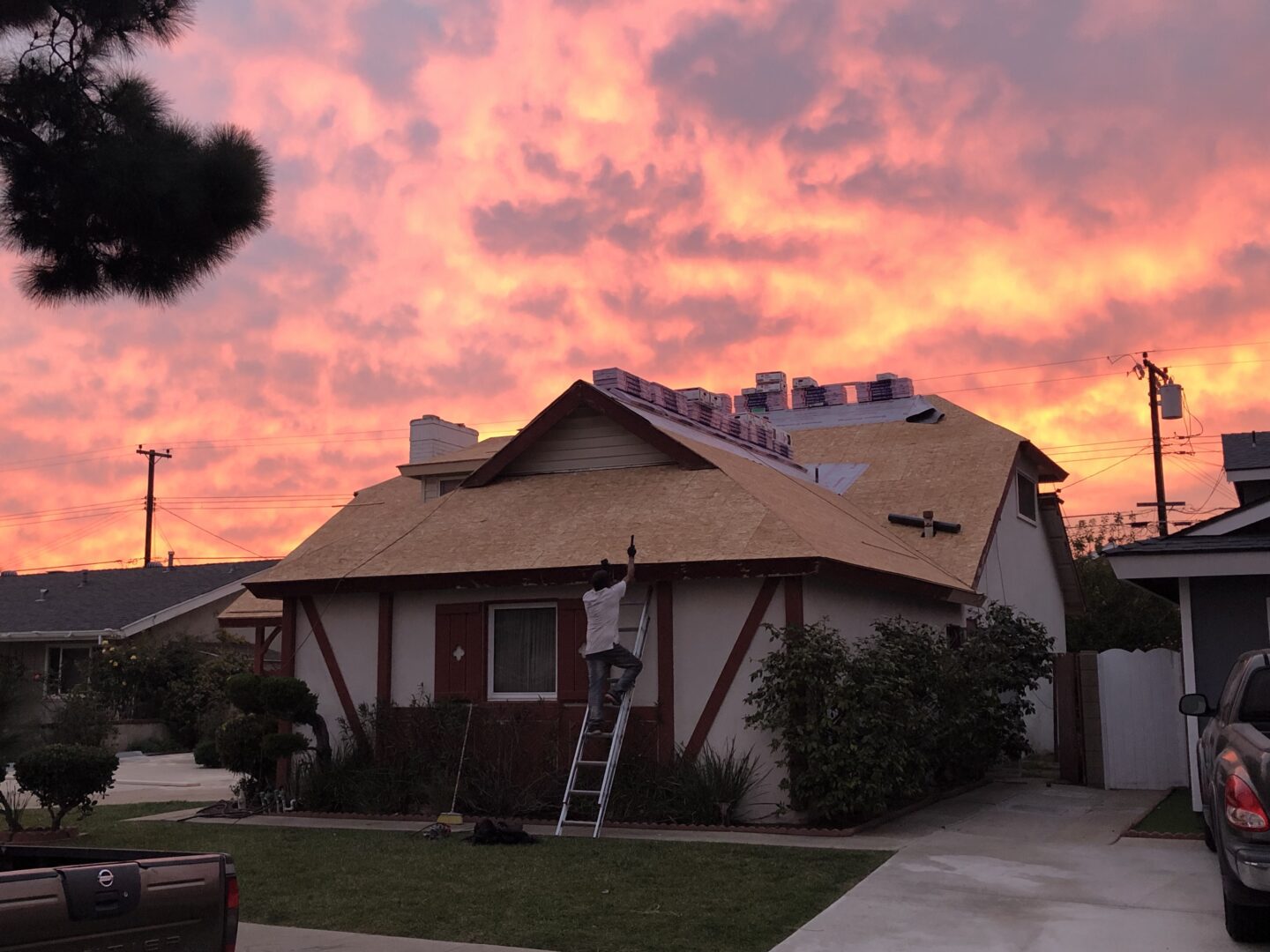 A person standing on the side of a house.