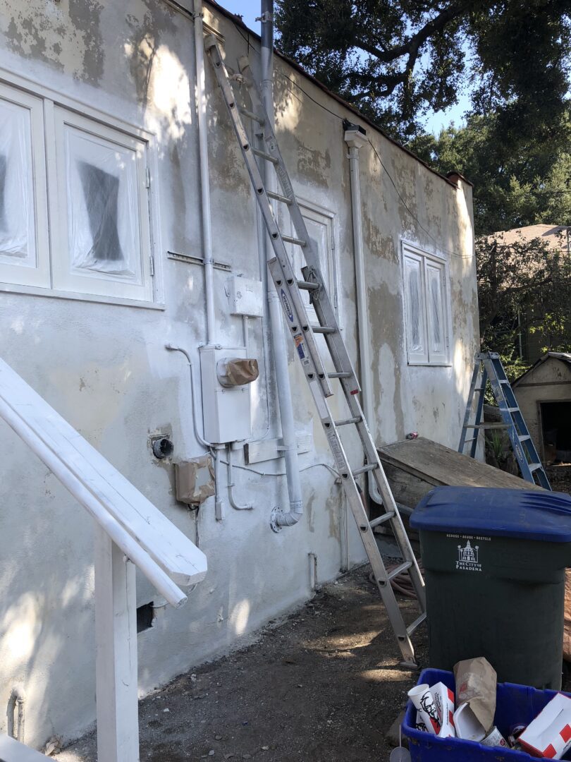 A ladder leaning up against the side of a building.