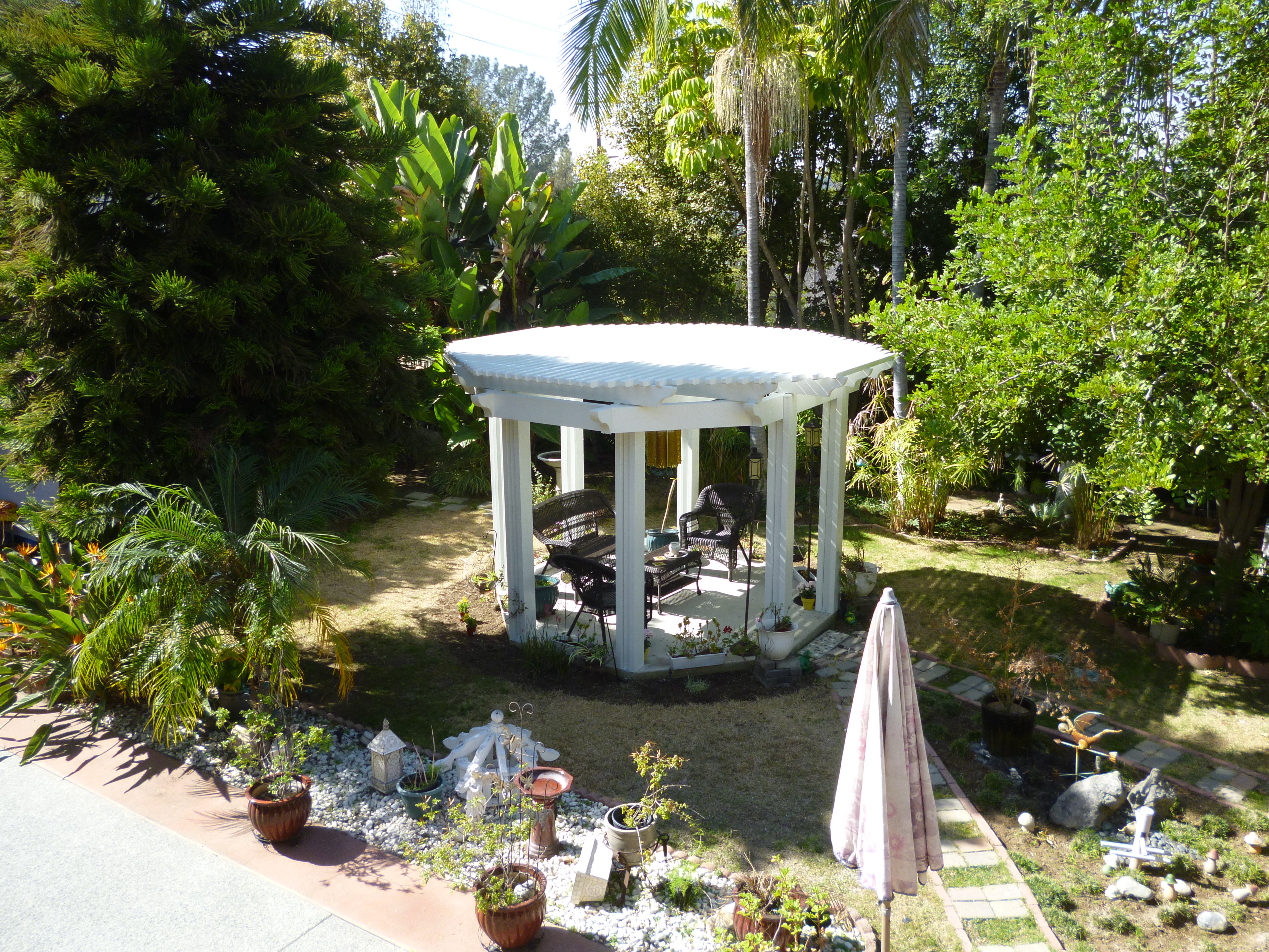 A gazebo in the middle of a garden.