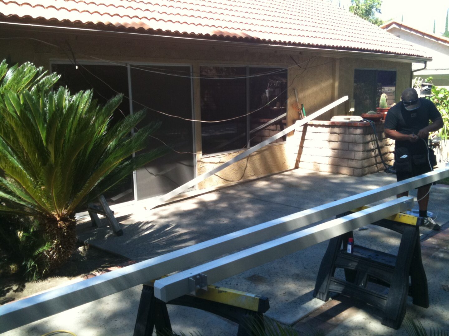 A large metal structure sitting in front of a building.