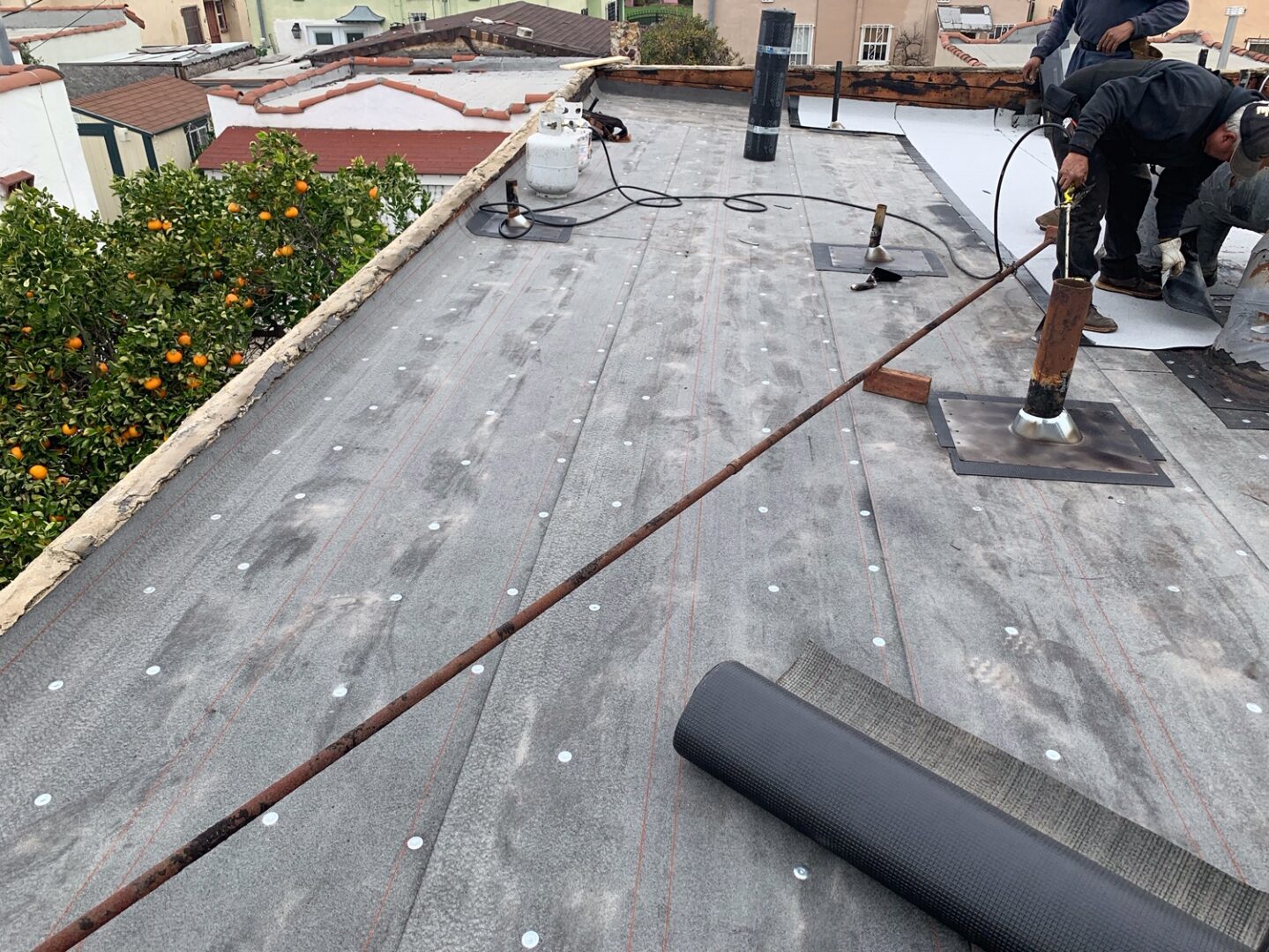 A man is cleaning the roof of his home.