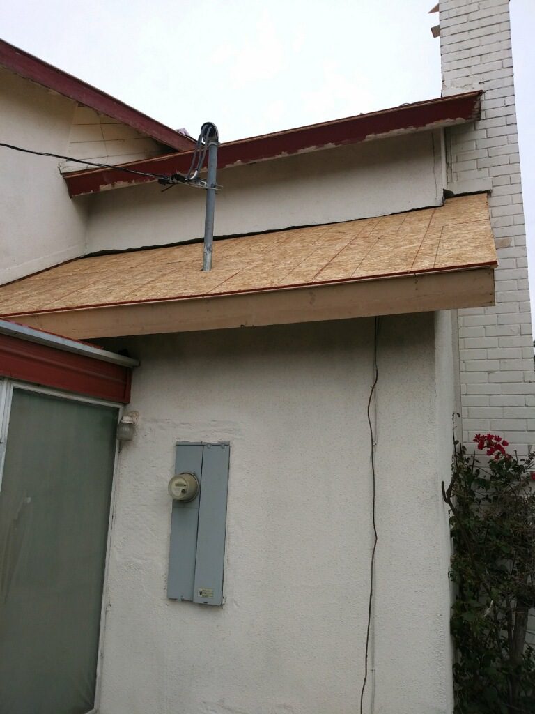 A building with a wooden roof and an air vent.