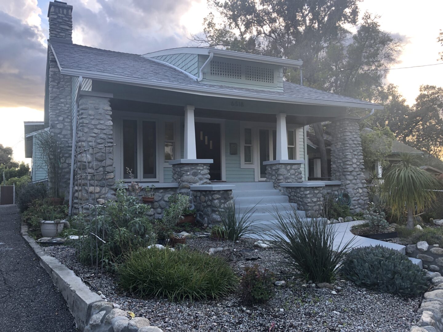 A house with a lot of plants in front