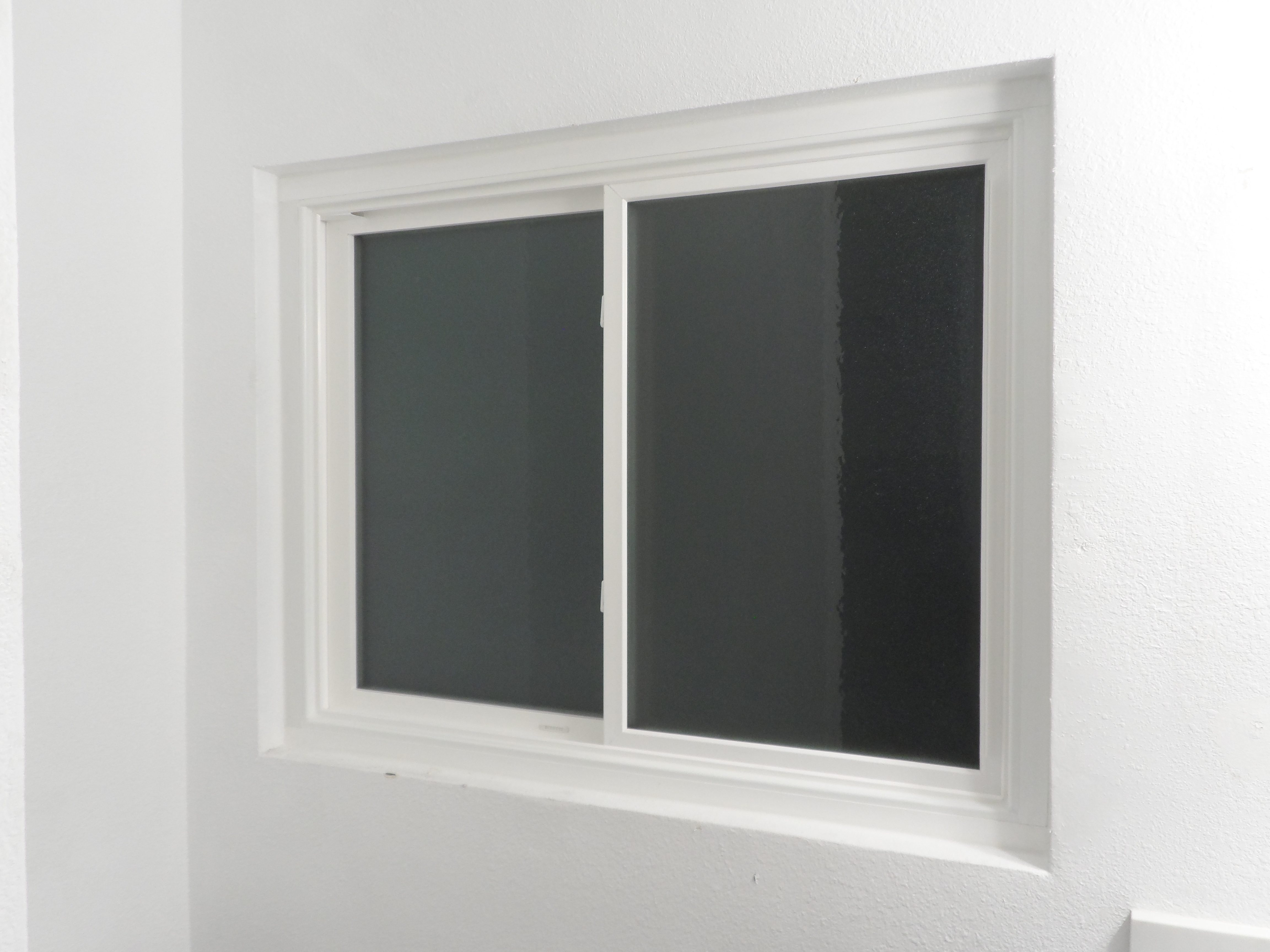 A window with a black glass in the middle of it