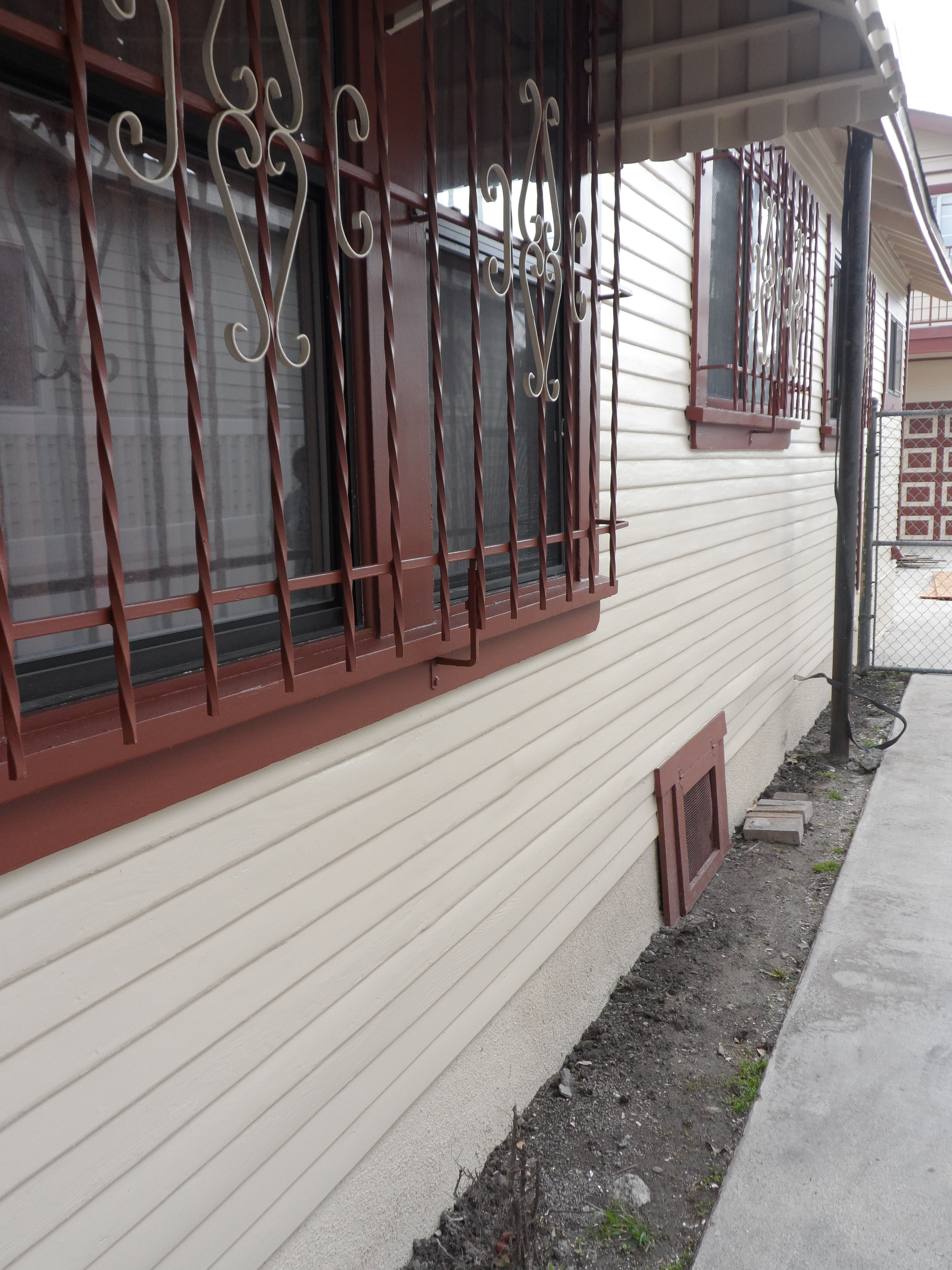 A house with a sidewalk and a window.