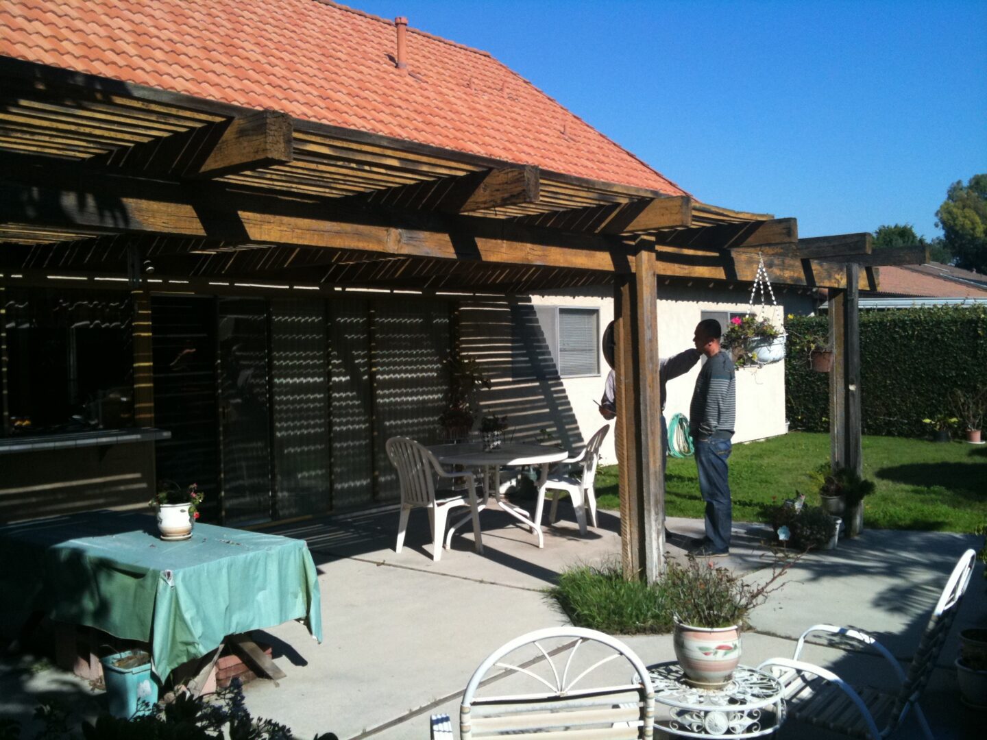 A man standing on the patio of his home.