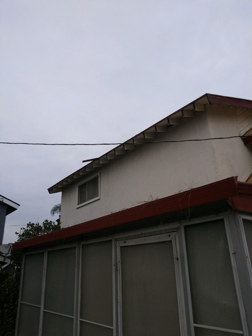 A house with a red roof and white walls