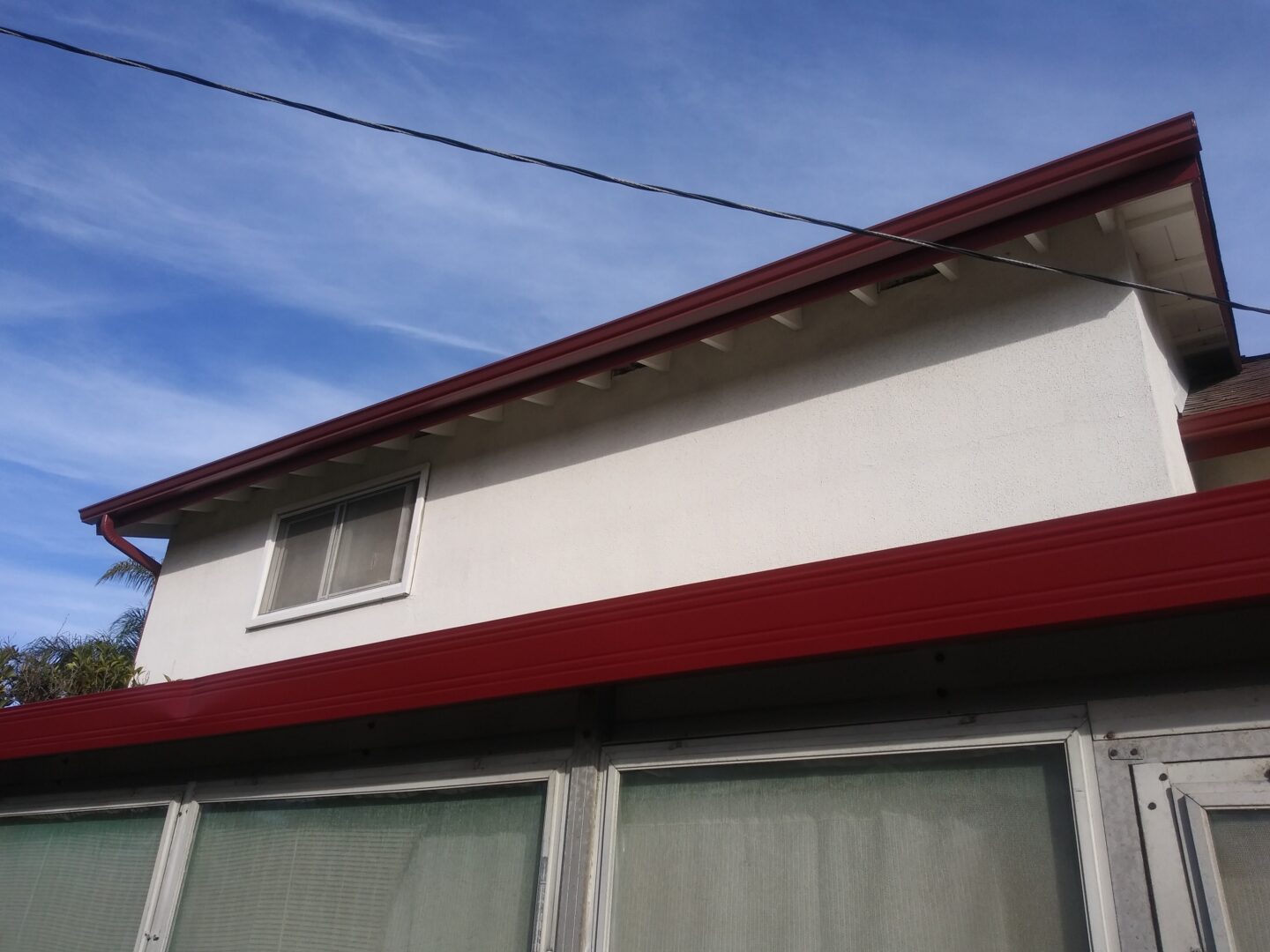 A white building with red trim and windows.