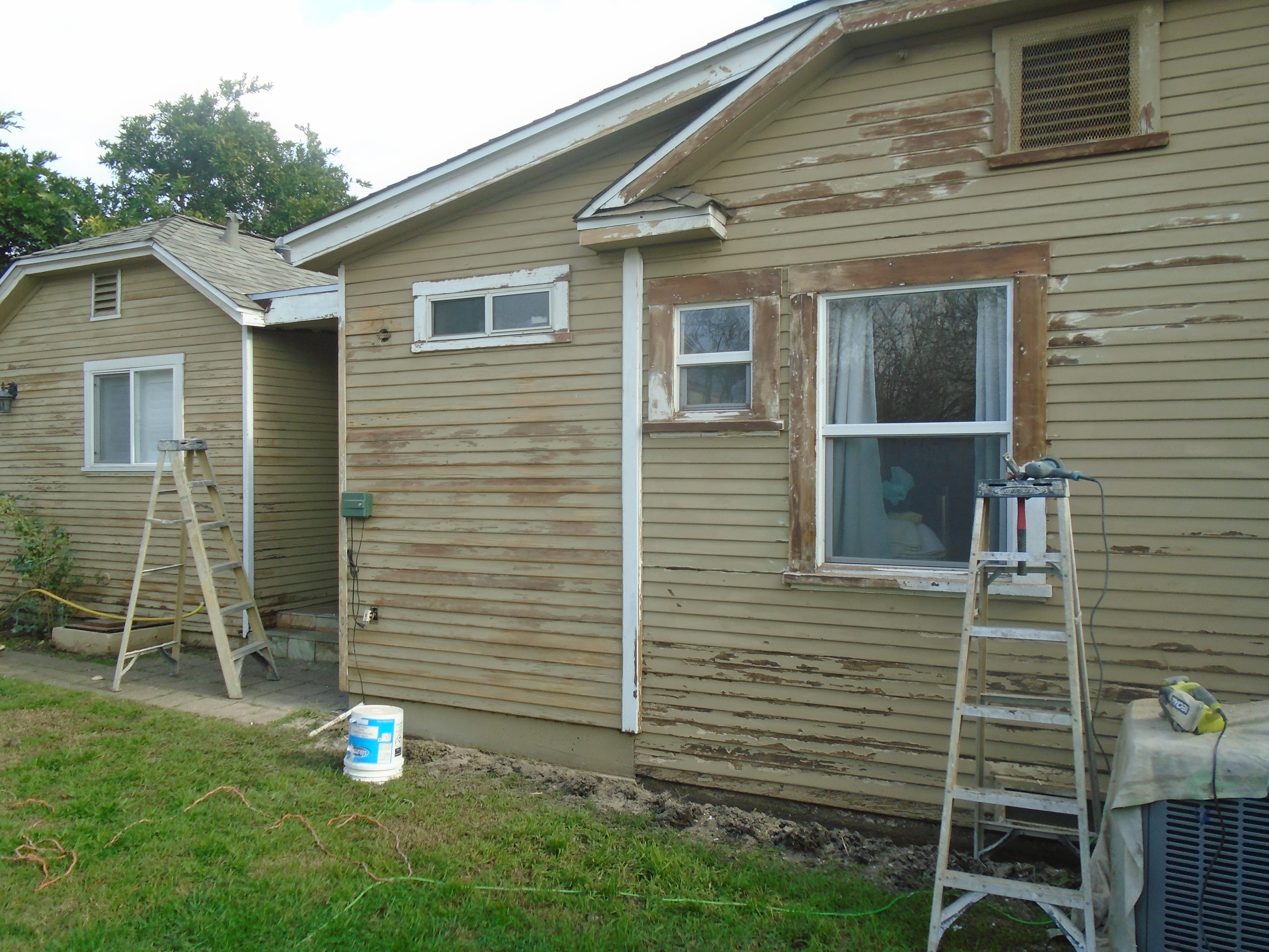 A house with paint on the side of it.