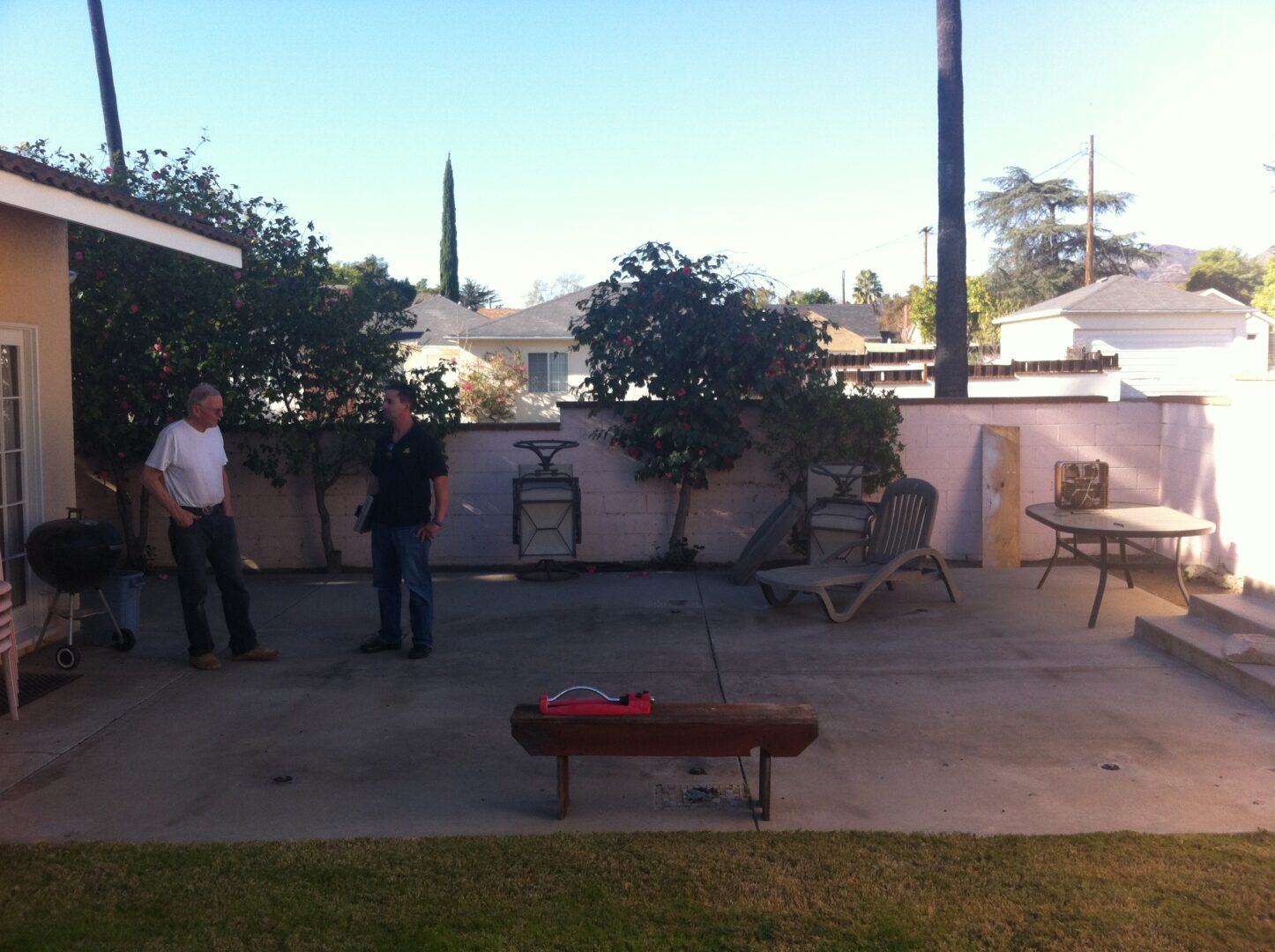 A group of people standing around in the yard.