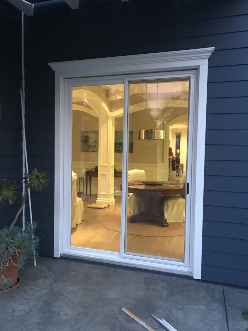 A large sliding glass door in the middle of a house.