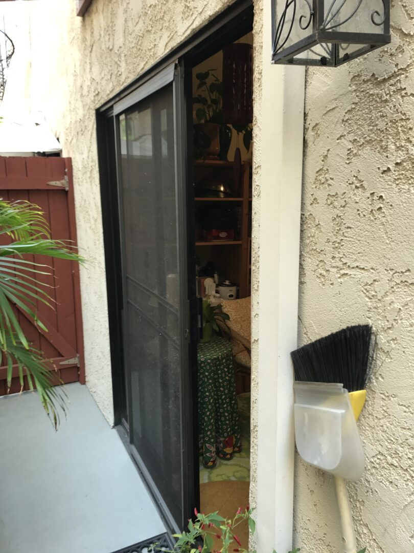 A cat sitting on the back of a sliding glass door.