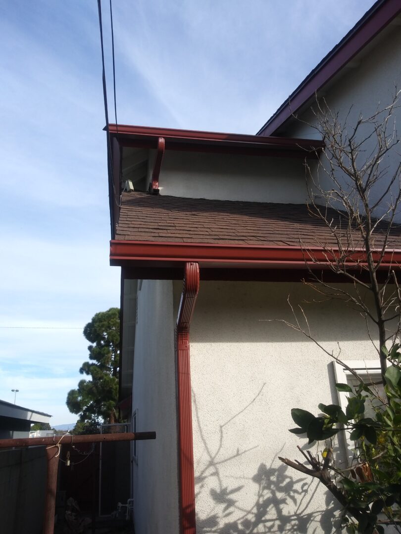 A house with a red roof and white walls.