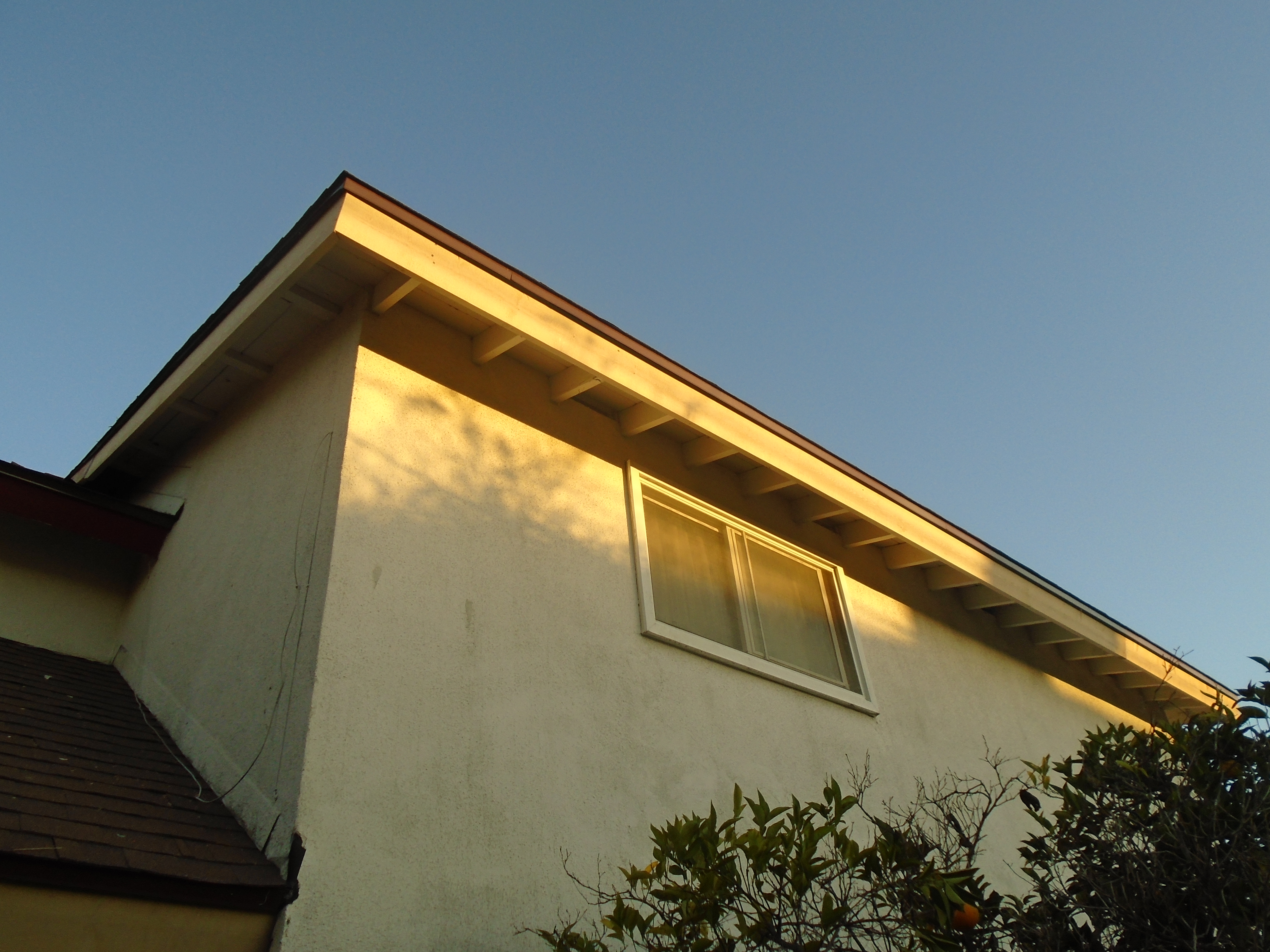 A house with a yellow roof and window.