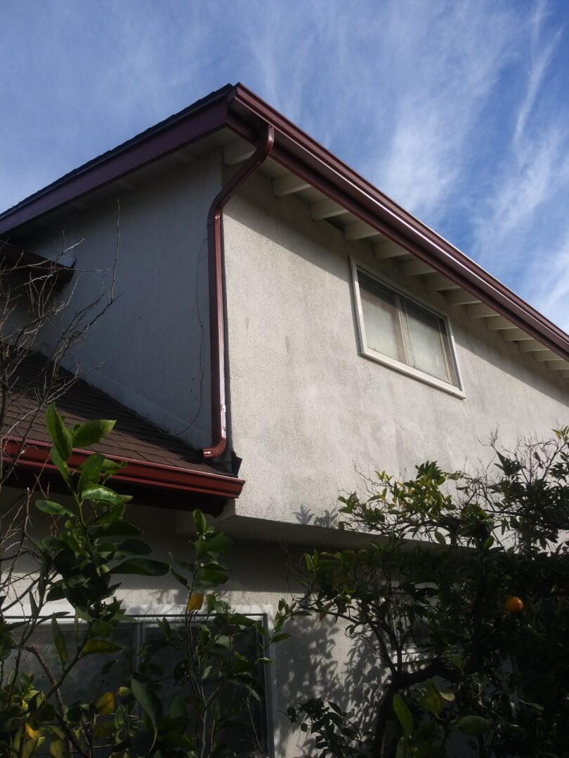 A house with a white wall and red trim.