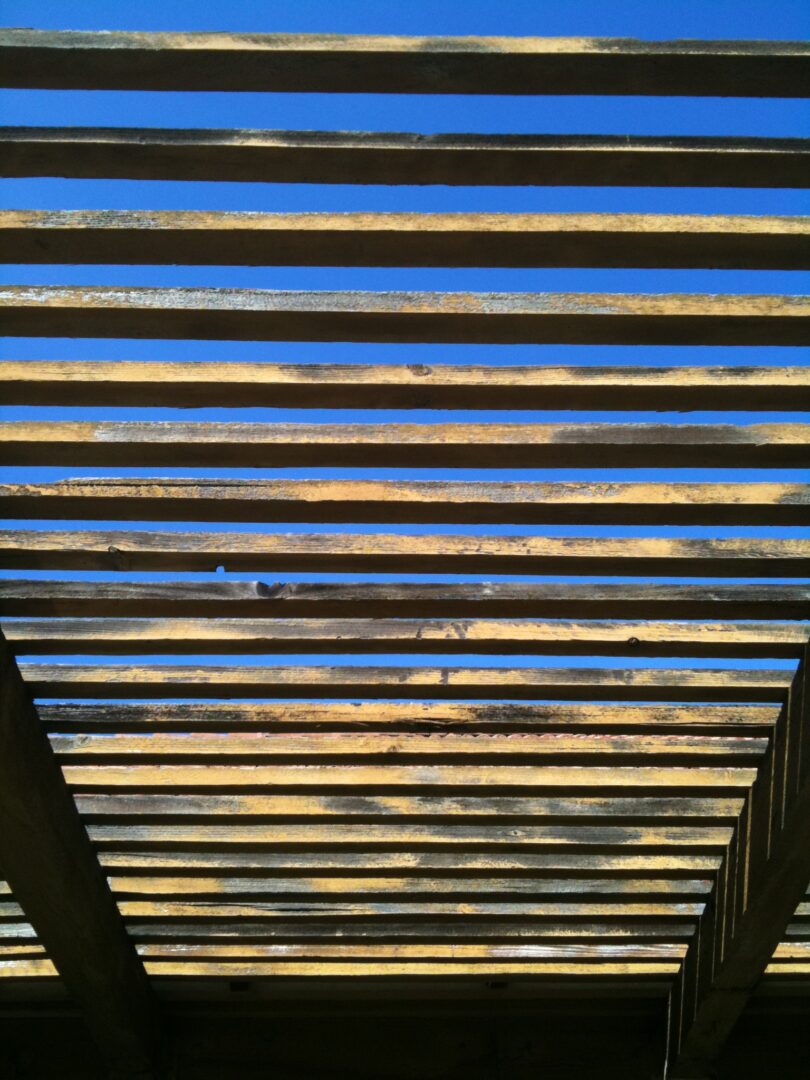 A wooden structure with some clouds in the sky