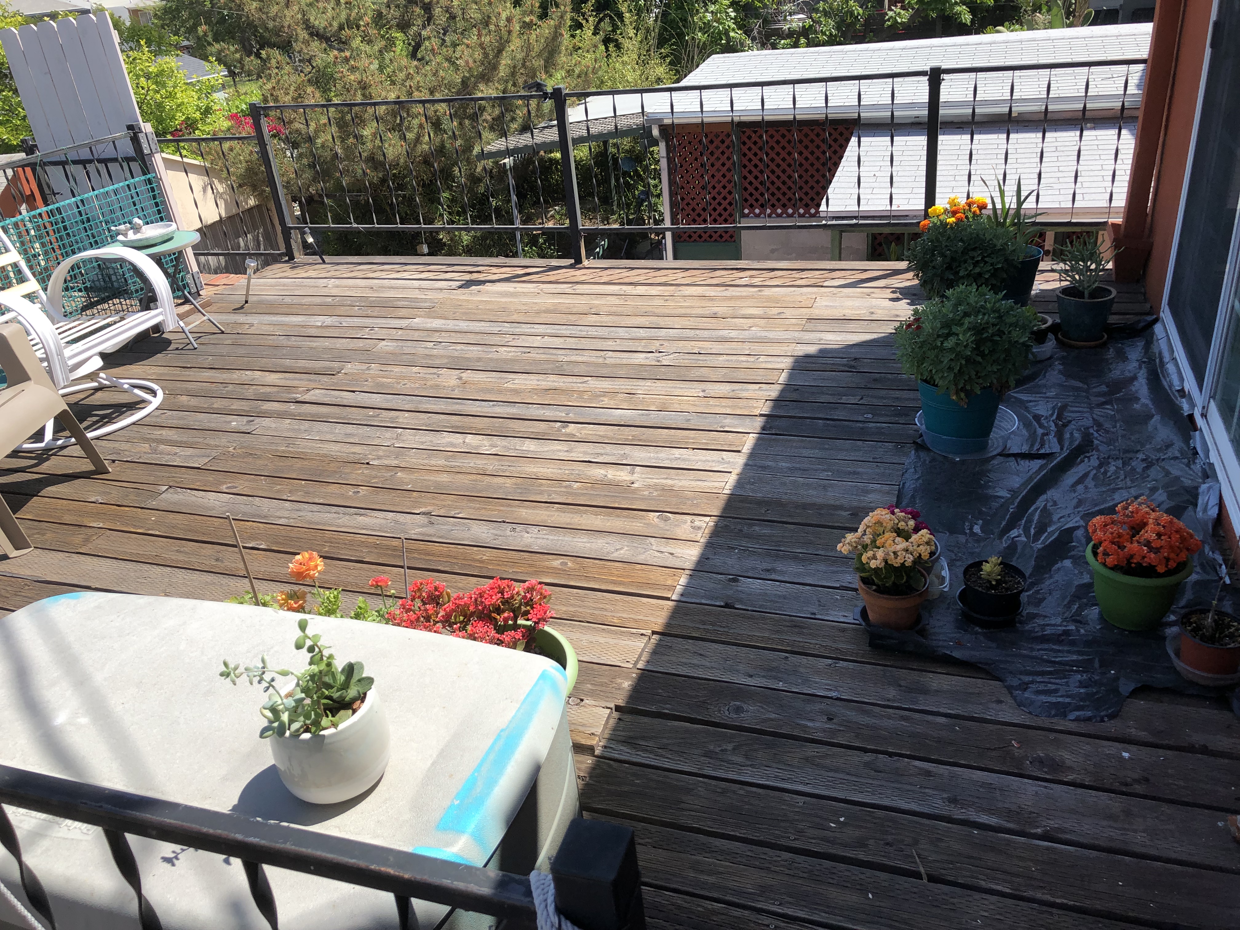 A table and chairs on top of a wooden deck.