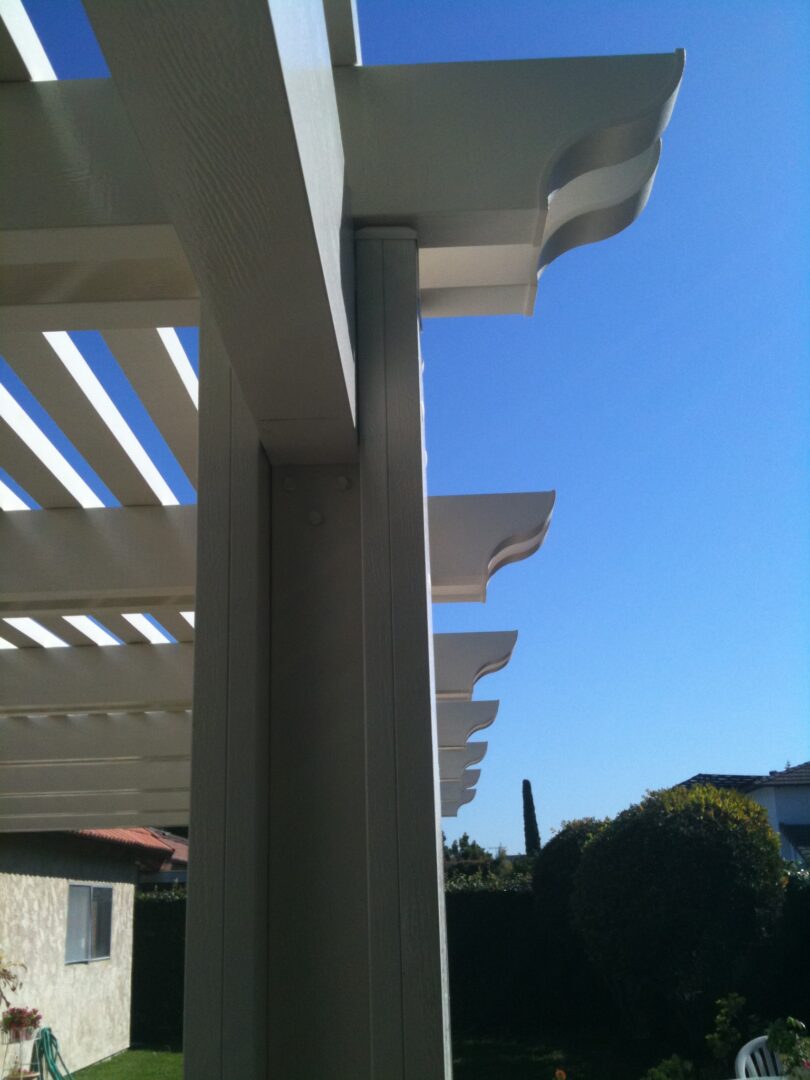 A view of the sky from under an attached pergola.