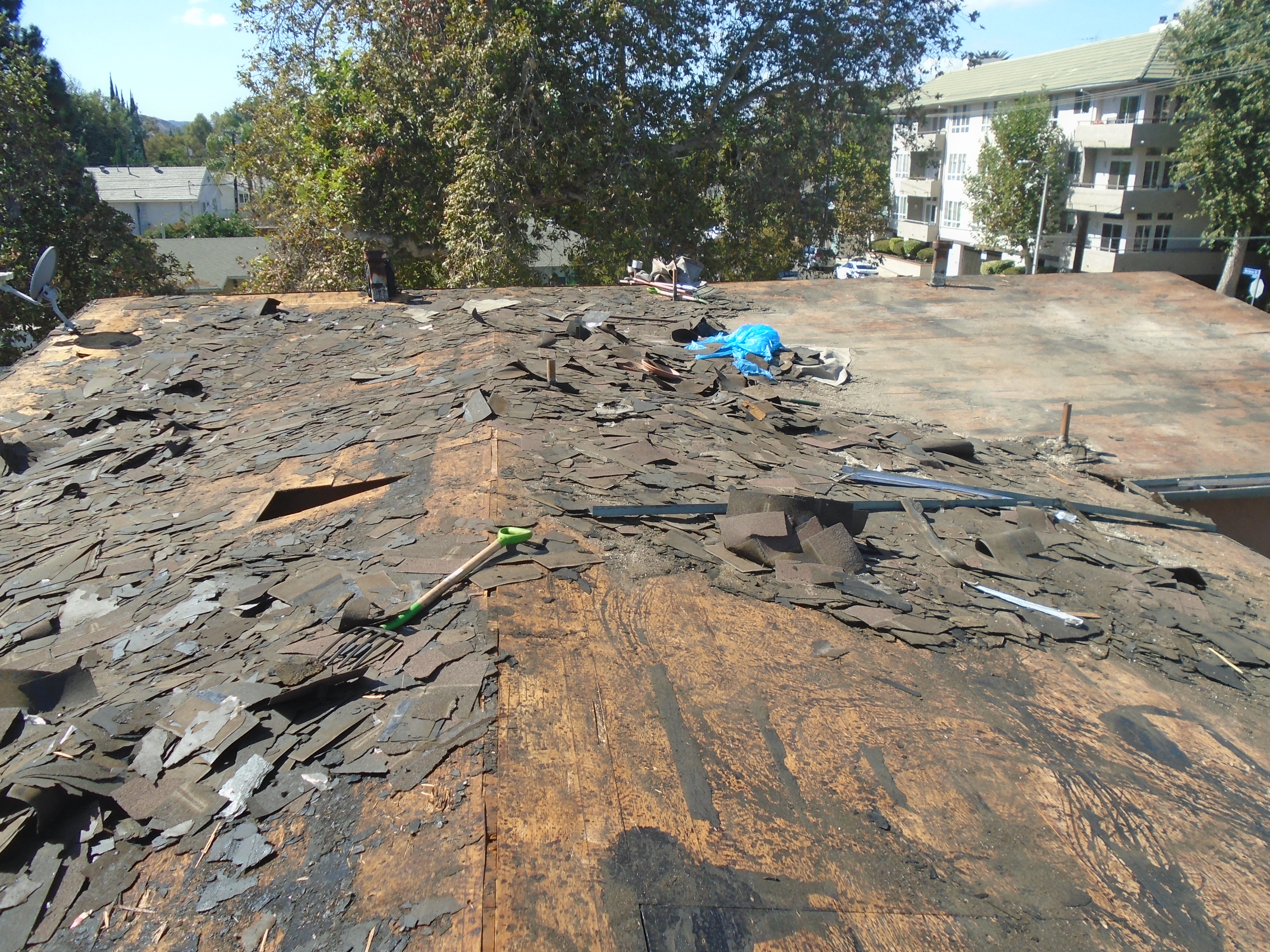 A view of the roof of a building that is being torn down.