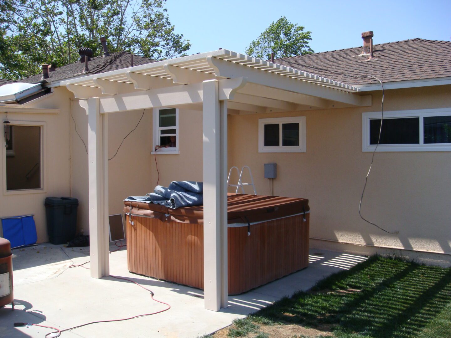 A hot tub is sitting under an awning.