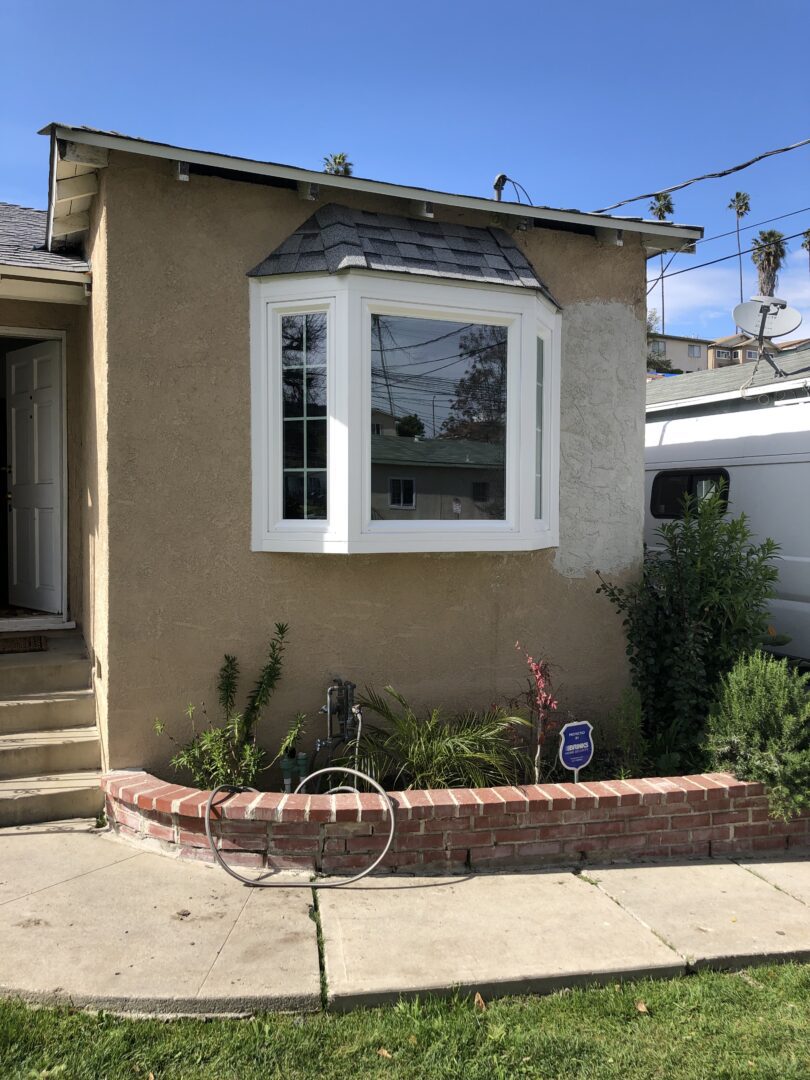 A house with a bike parked in front of it.