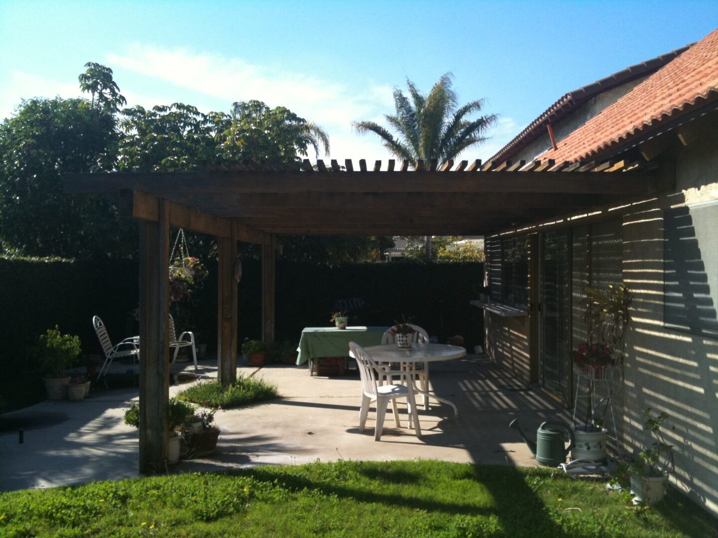 A patio with a table and chairs in the middle of it.