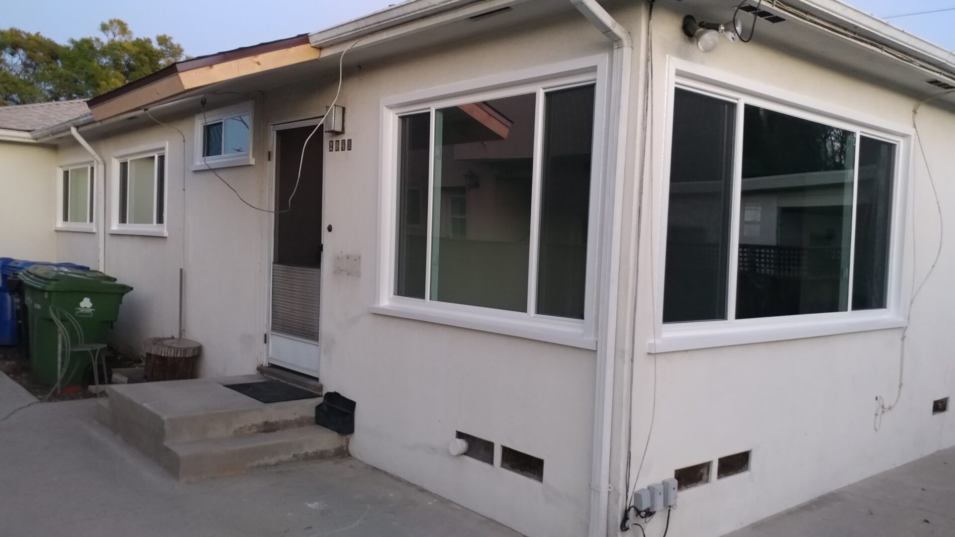 A white house with two windows and a door.