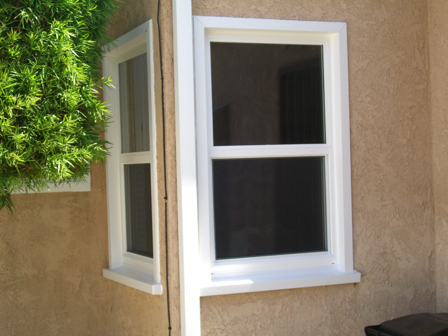 A window with two windows on the outside of a house.