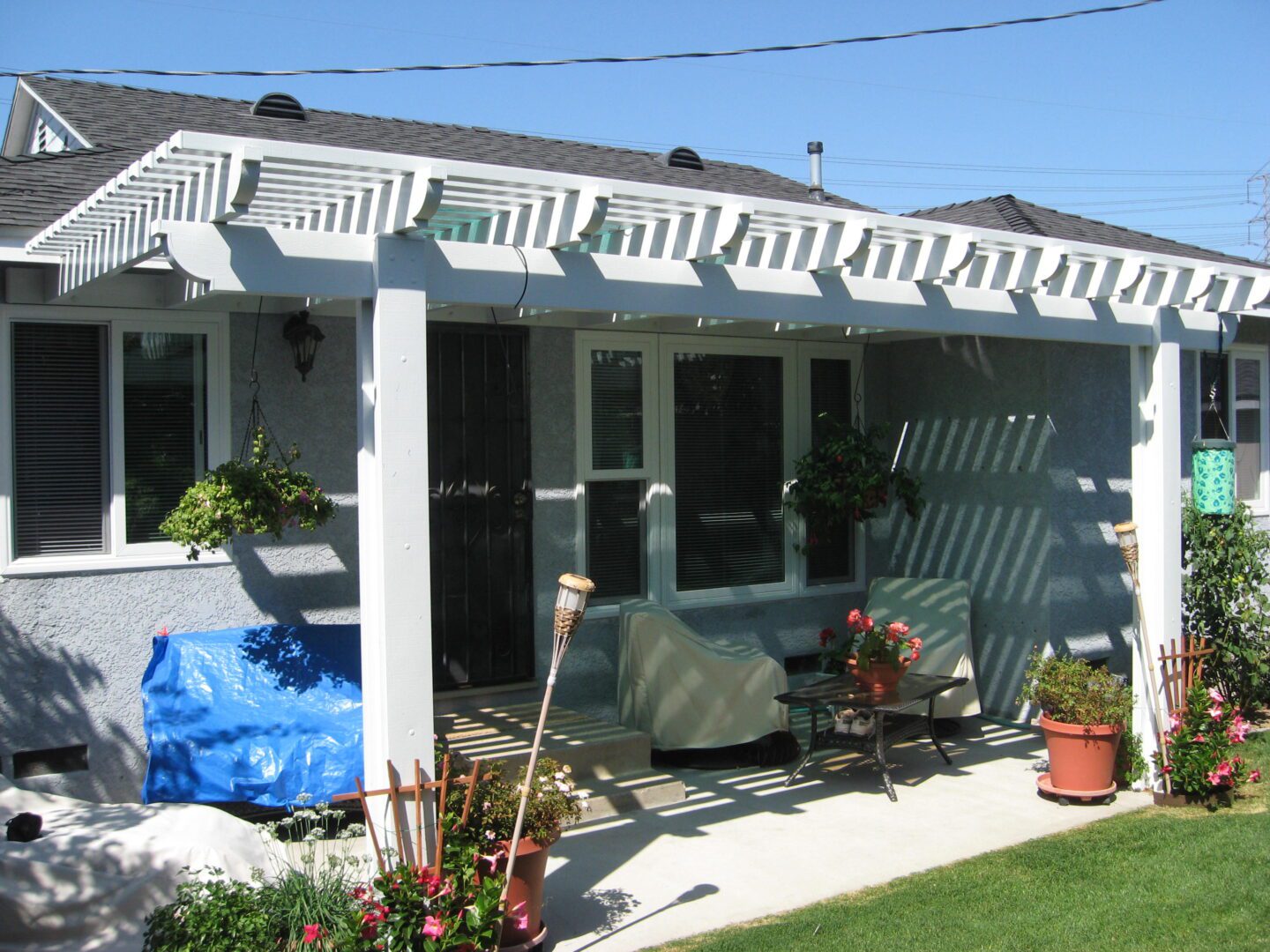 A patio with a grill and covered area.