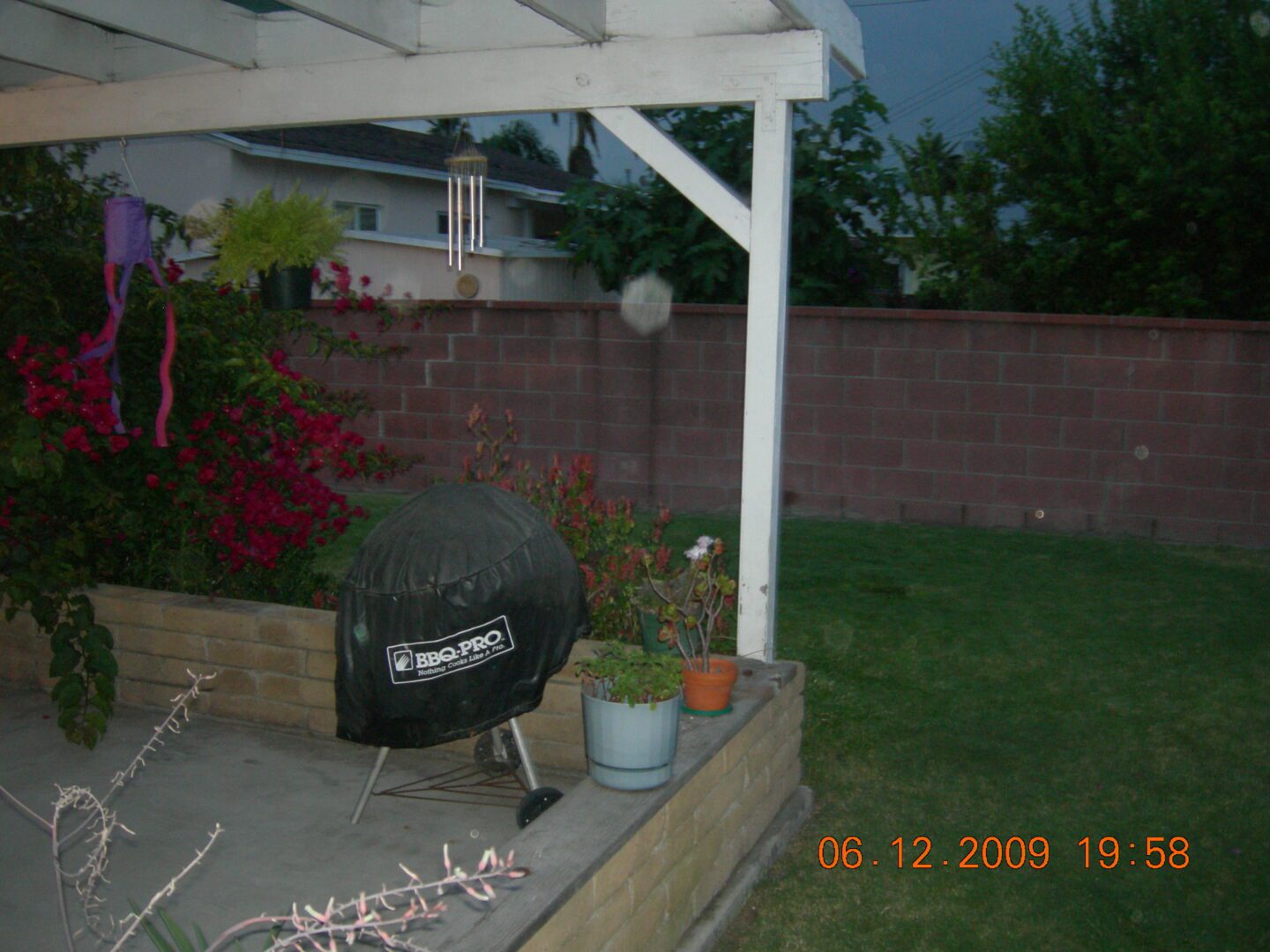 A grill sitting on top of a wooden deck.