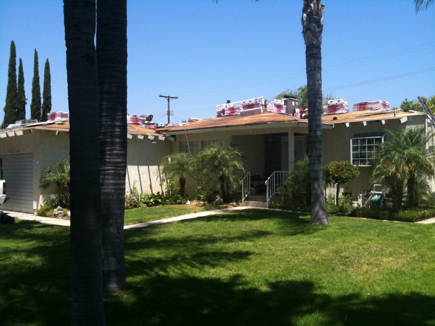 A house with some trees and grass in front of it