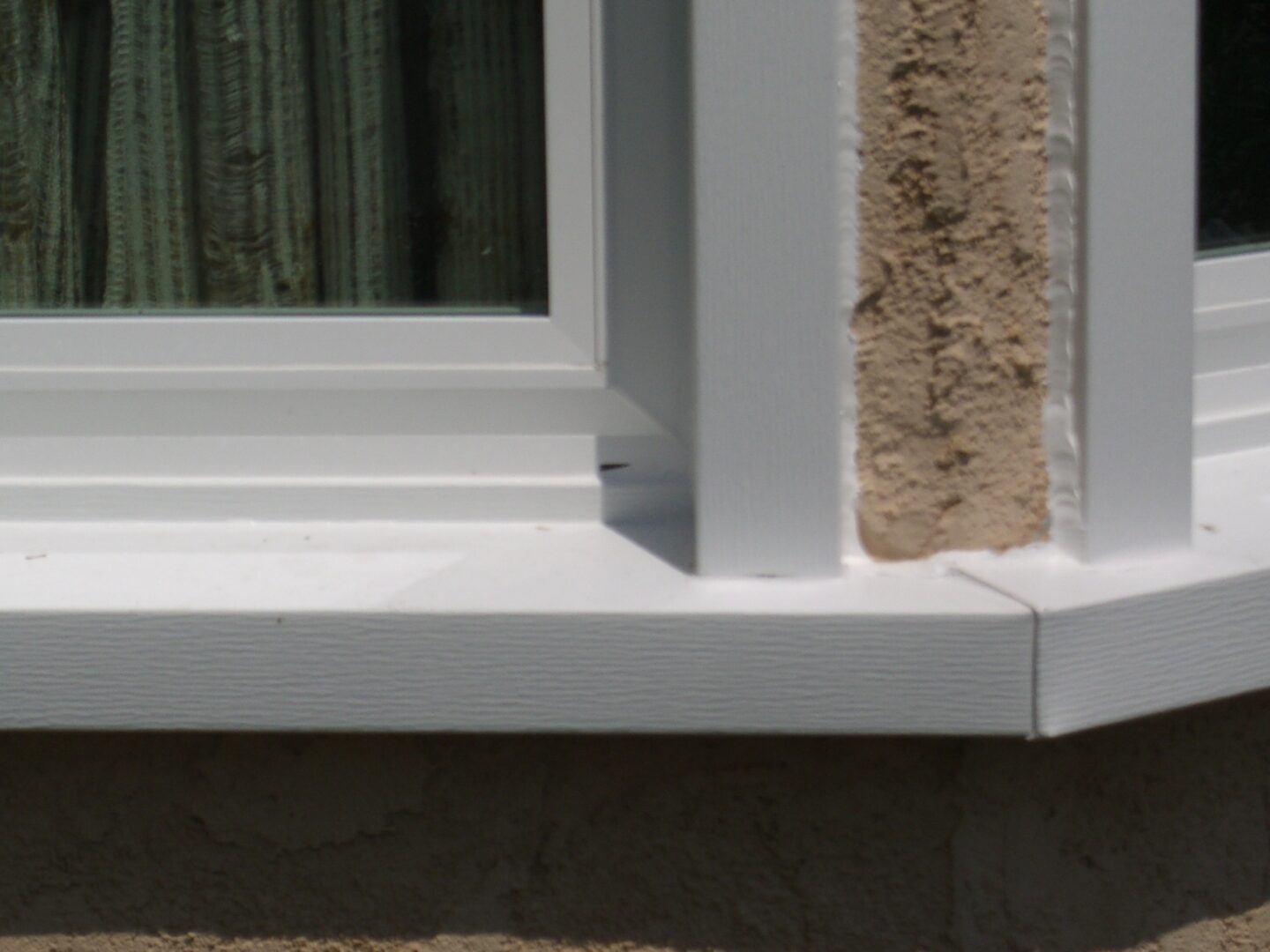 A close up of the corner of a window sill