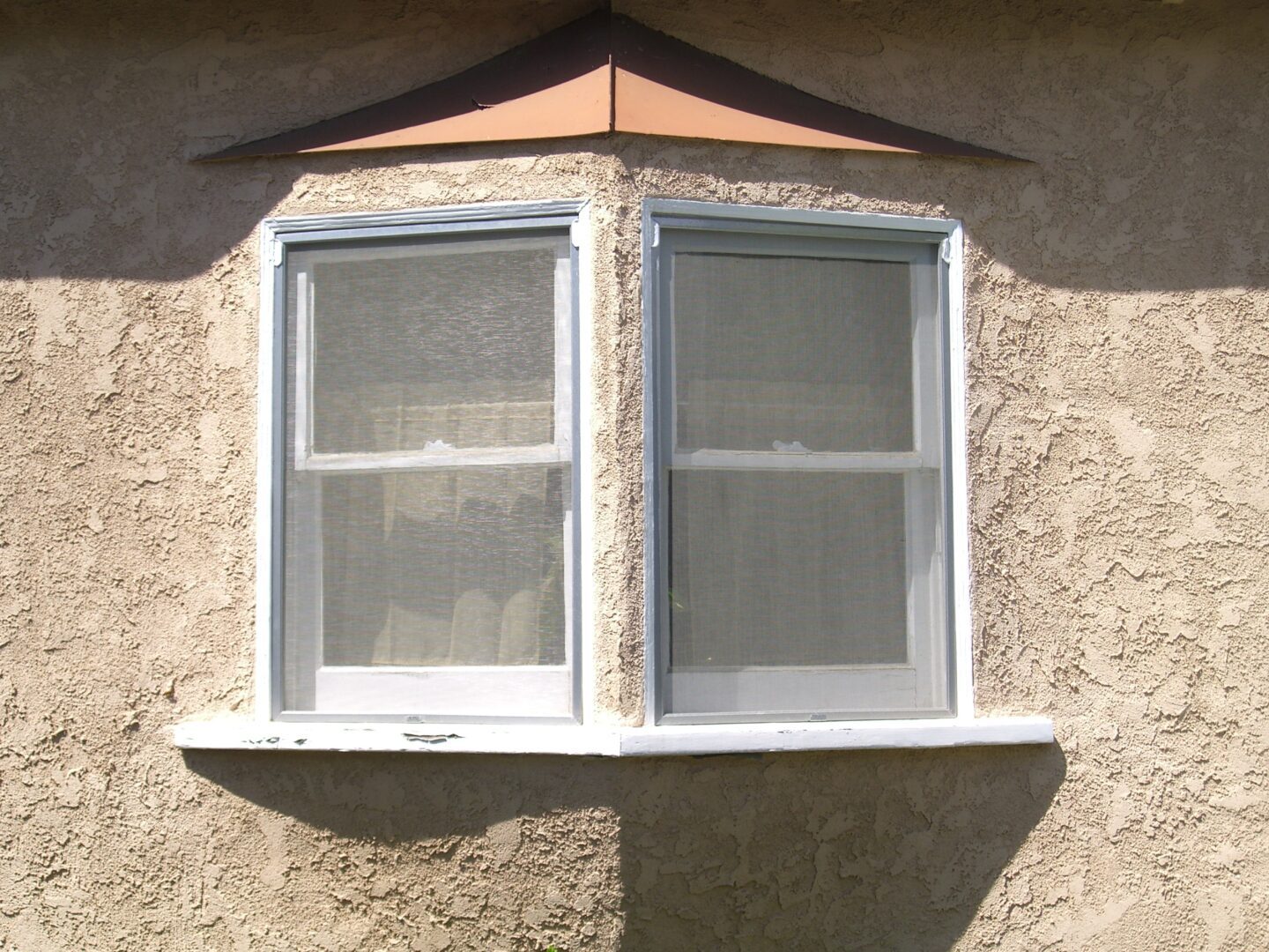 A window with two windows on the outside of it.