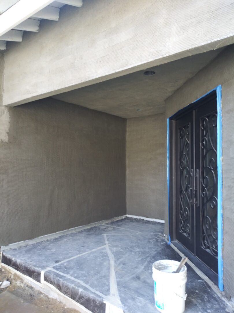 A door way with two doors and a cement floor.