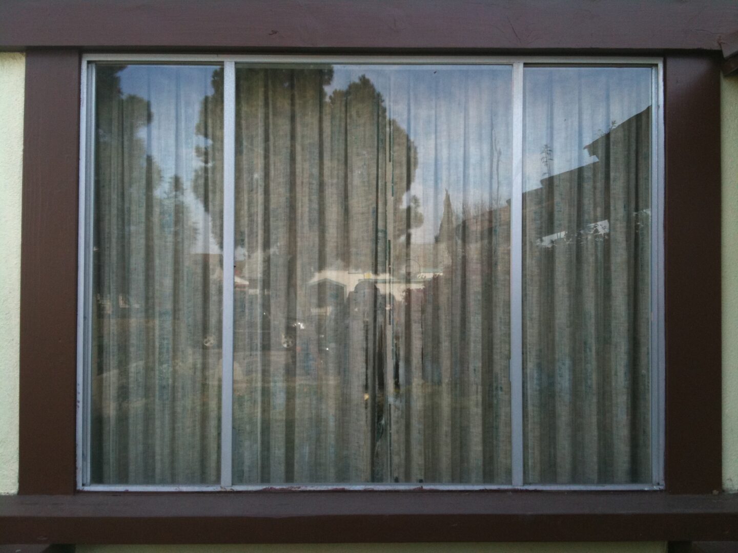 A window with vertical blinds on the outside of it.