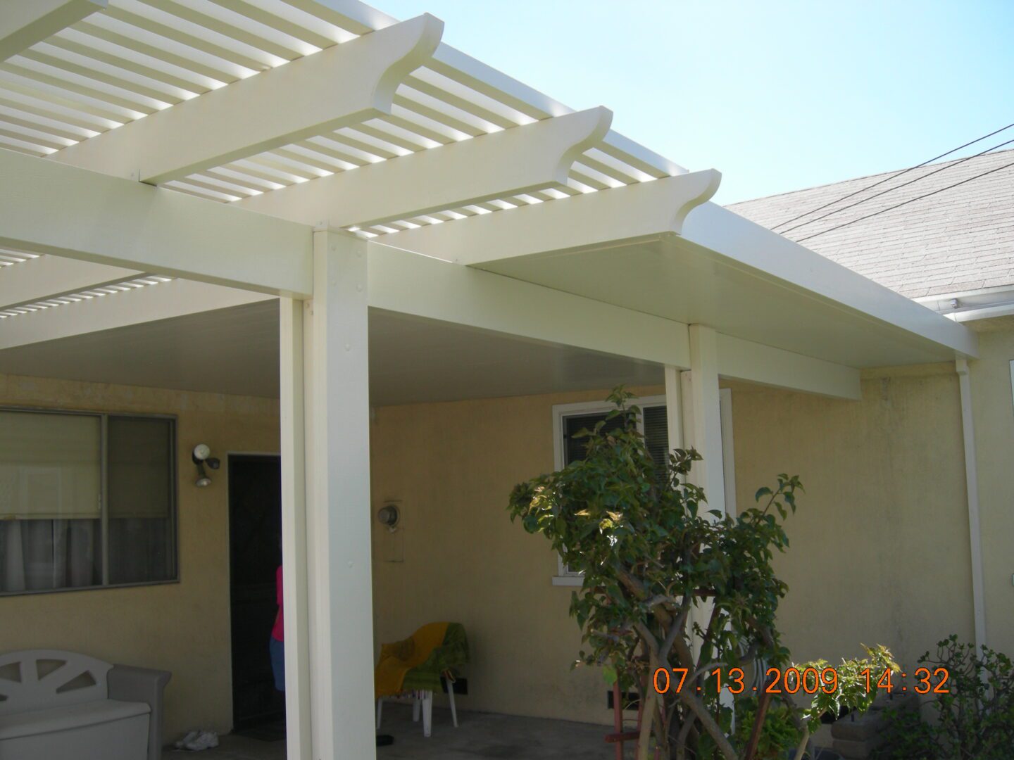 A patio cover with a flower pot in the middle of it.