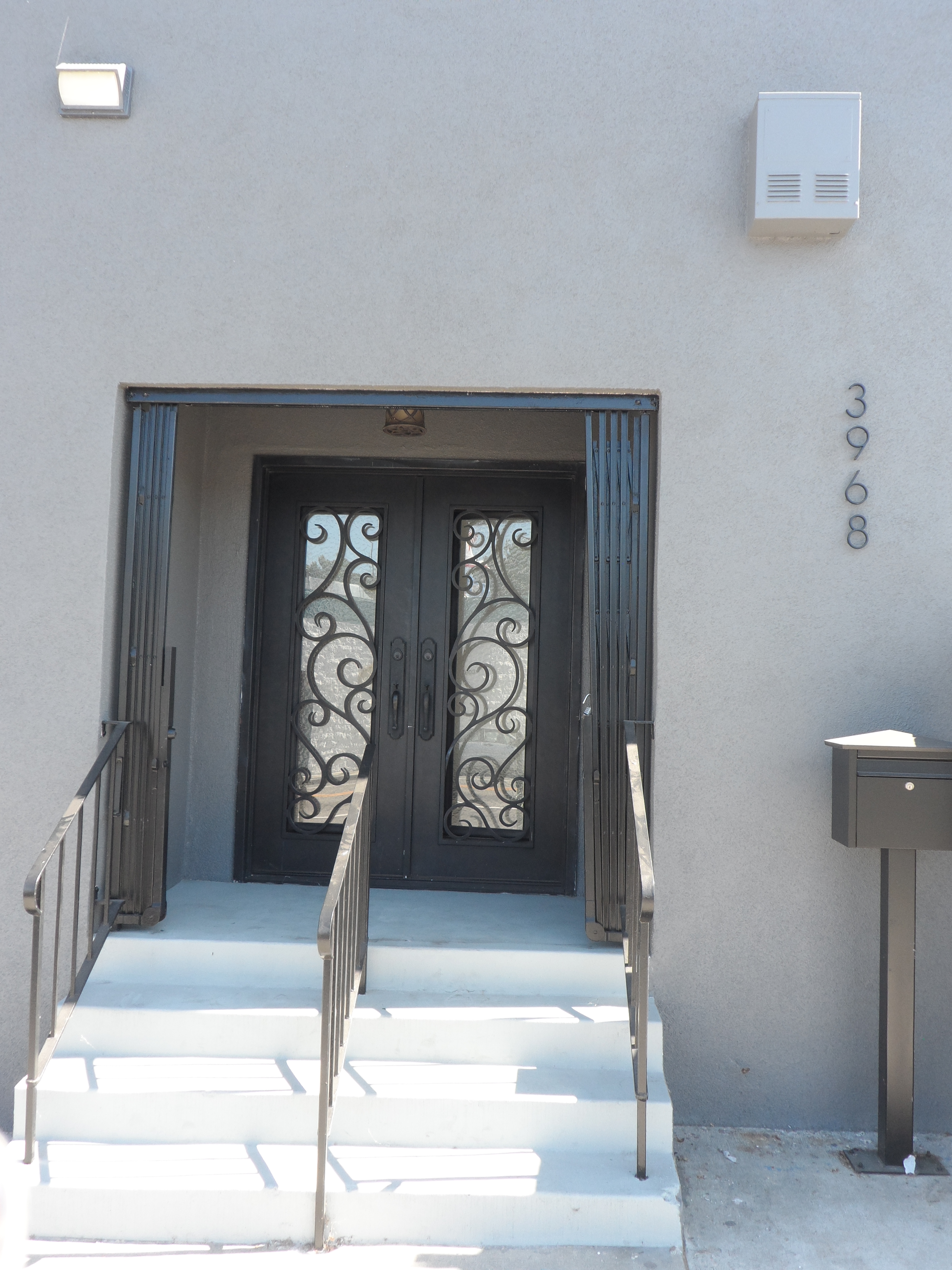 A door way with two doors and steps leading to it.