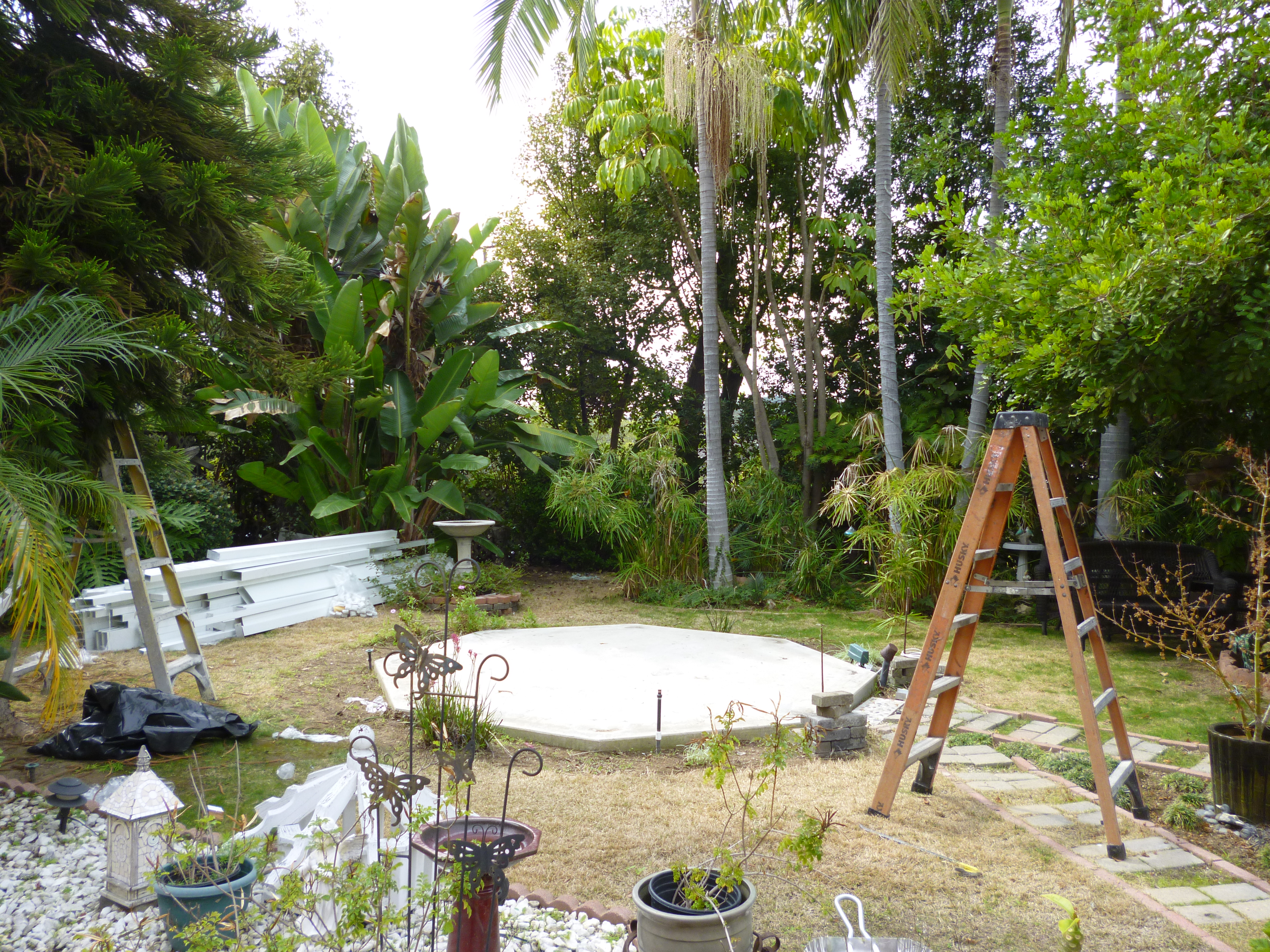 A round pool is being built in the yard.