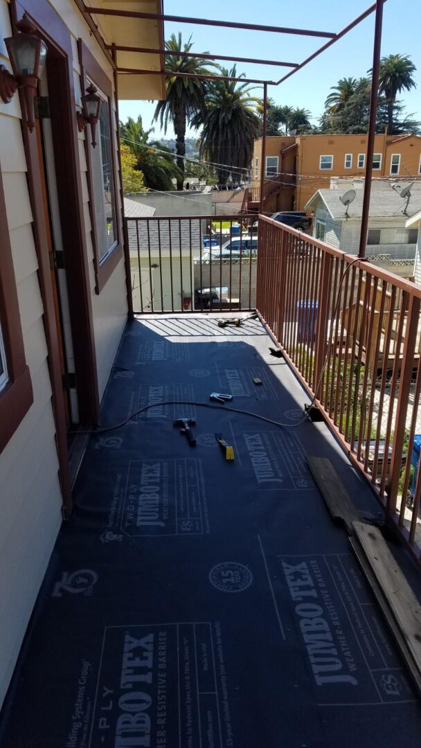 A balcony with some flooring and tools on it