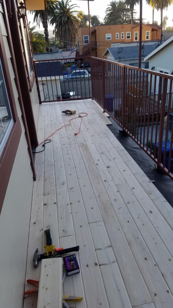 A deck being built with wood and metal railing.