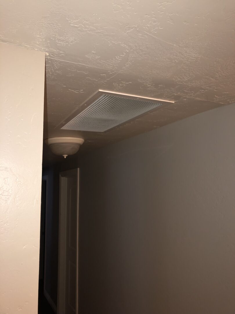 A ceiling fan in the corner of a room.