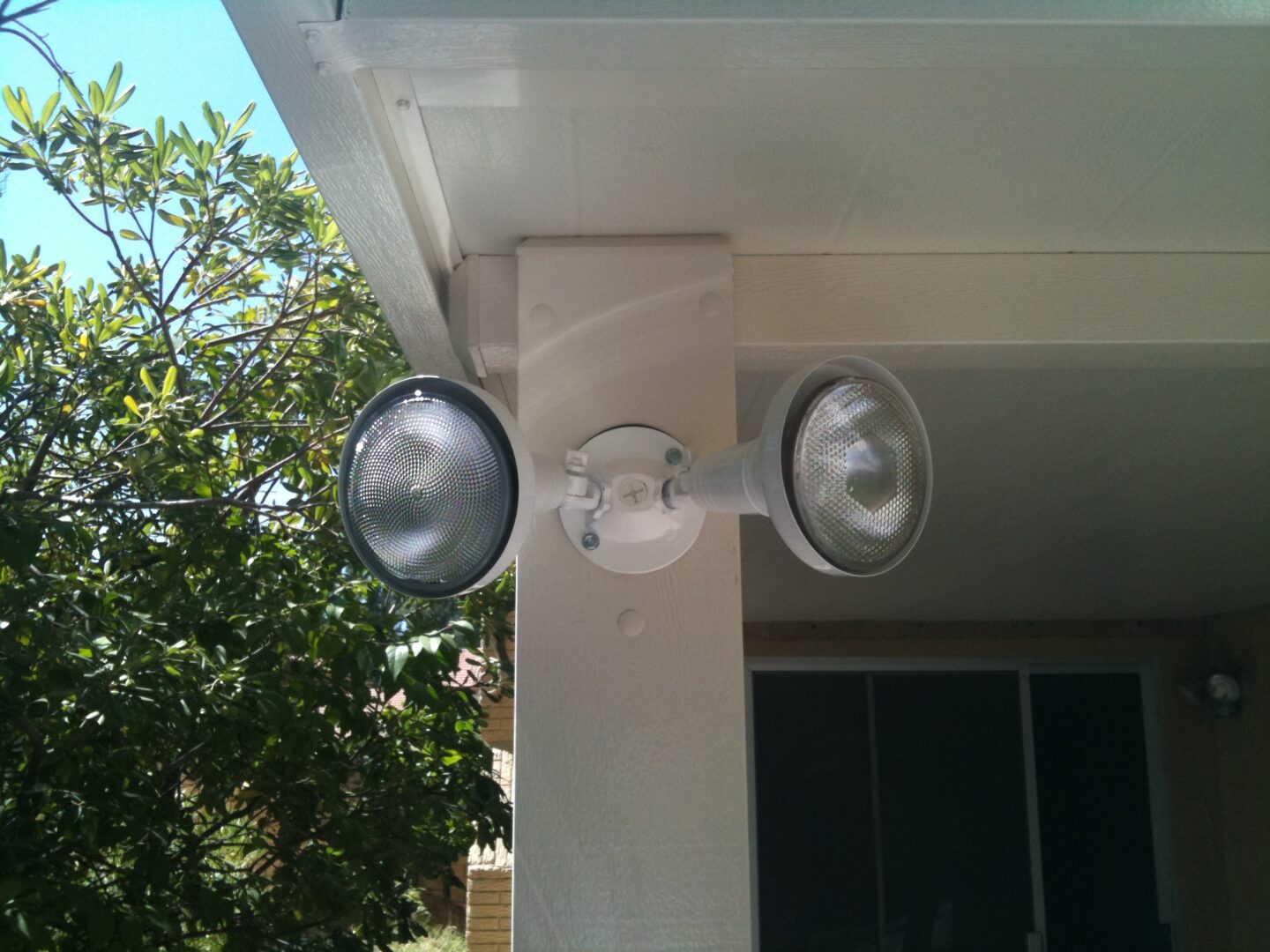 A porch with two lights on the side of it.