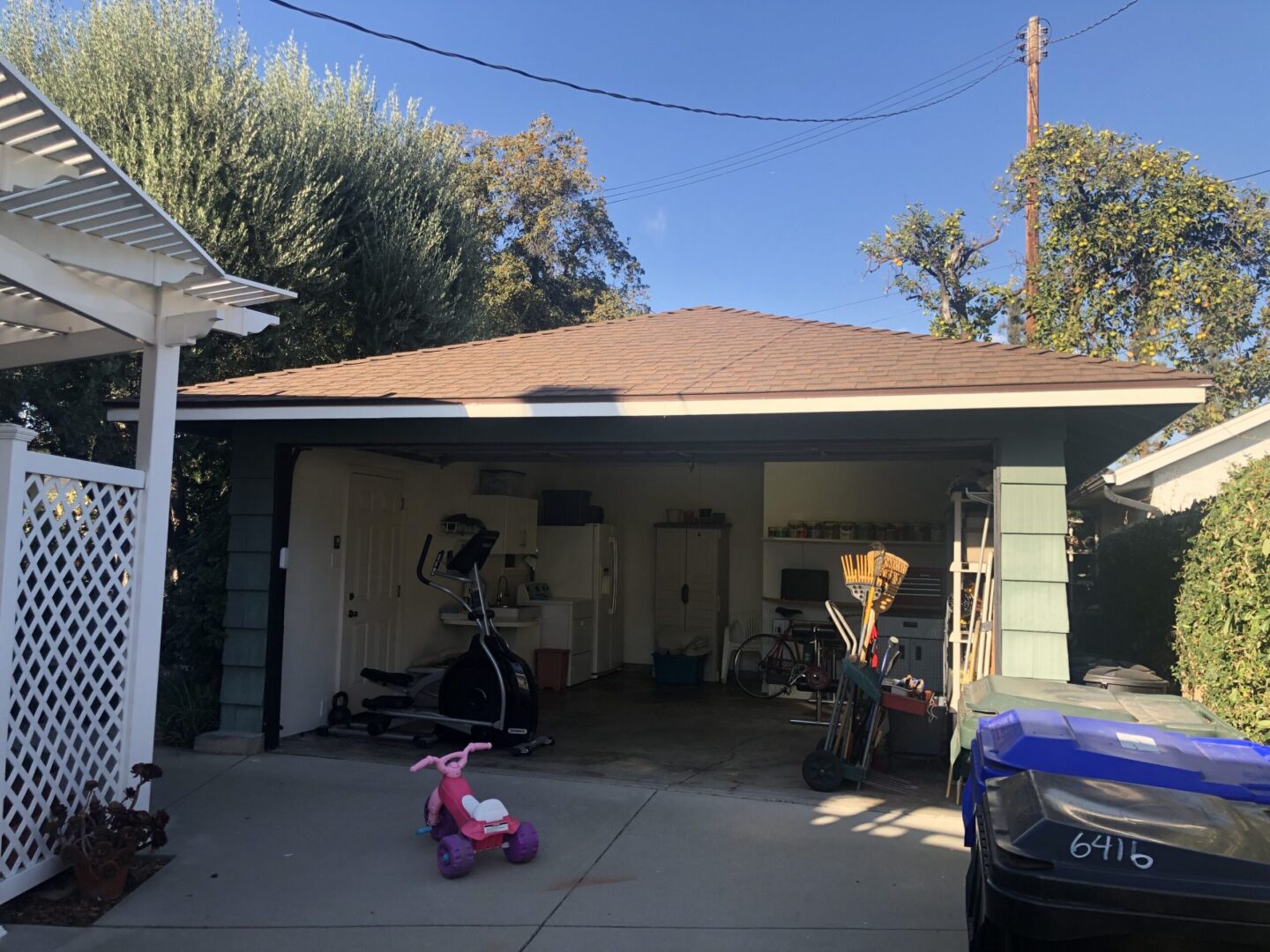 A garage with two cars parked in it.