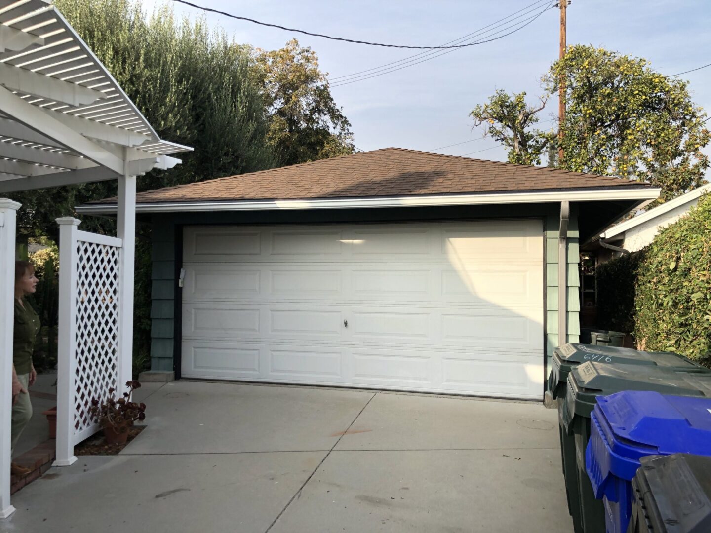 A garage door is open and the outside of it has been painted white.